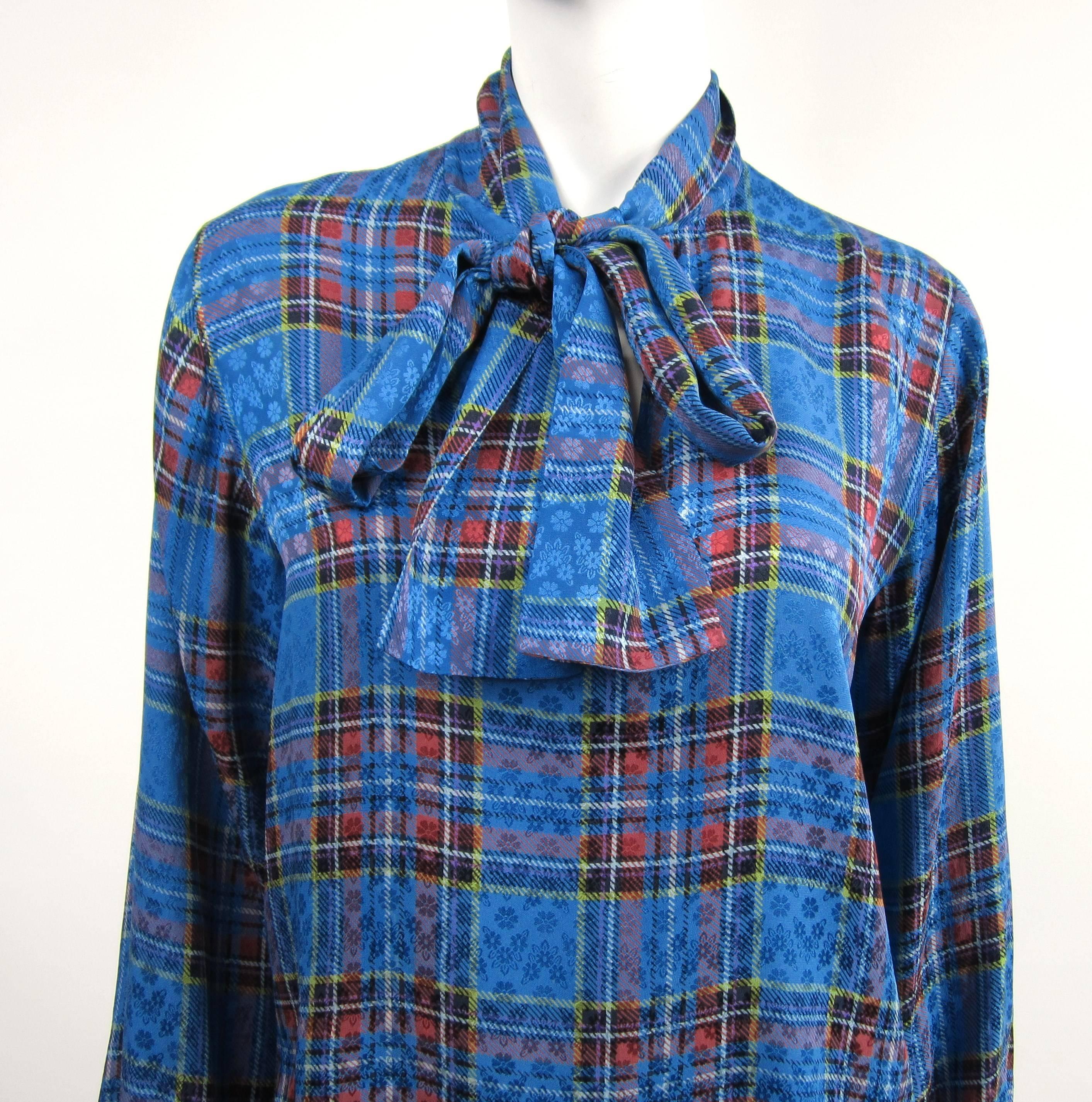 YSL Blue Silk Checkered Plaid Rive Gauche Silk Blouse with Scarf Bow on the neckline. No buttons, it slides overhead. Has Buttoned cuffs. Measuring- Up to 40 on the Bust - Up to 40 waist--- 25 inches long-- 23.5 long sleeve. This is out of a massive