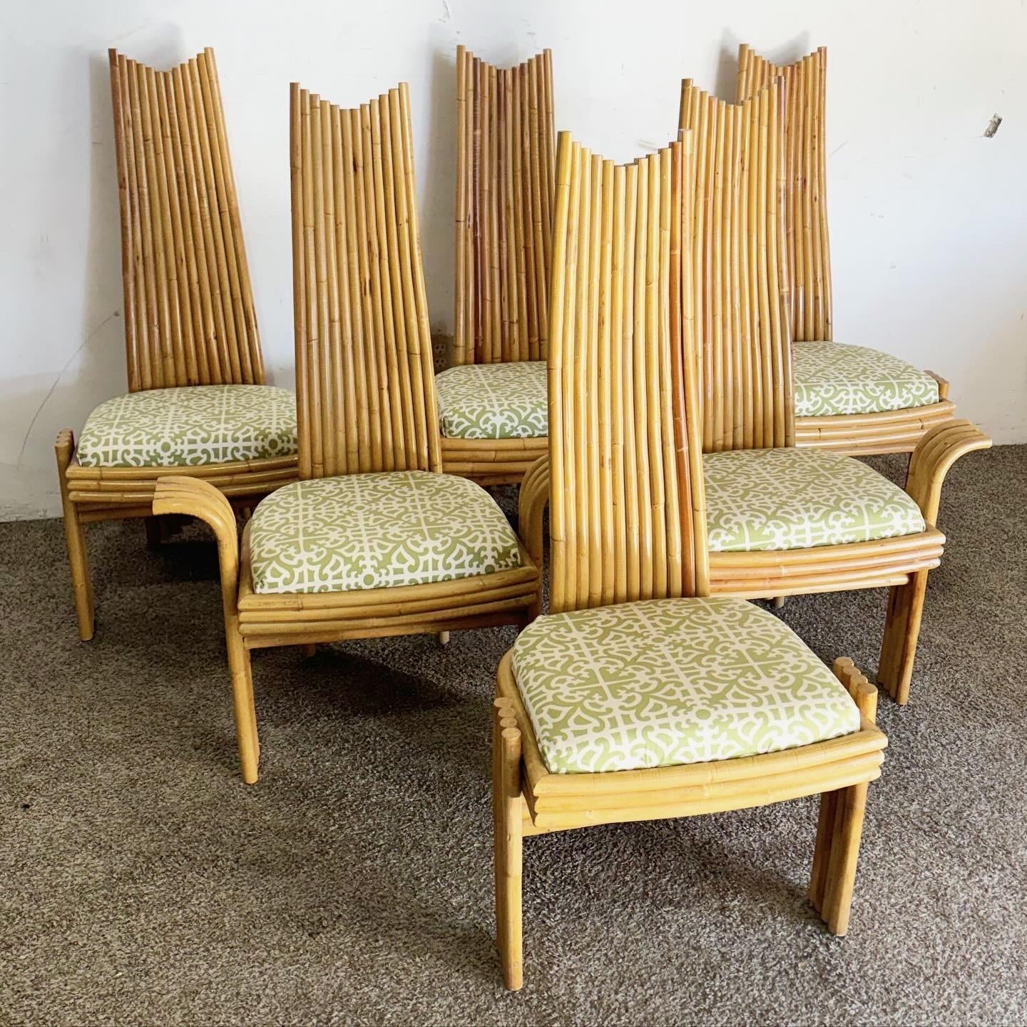 Travel back to the 1970s with this set of six Vintage Boho Chic High Back Bamboo Dining Chairs. This set includes two captain's chairs and four side chairs, all highlighting the natural allure of bamboo. The high back design offers elegance and