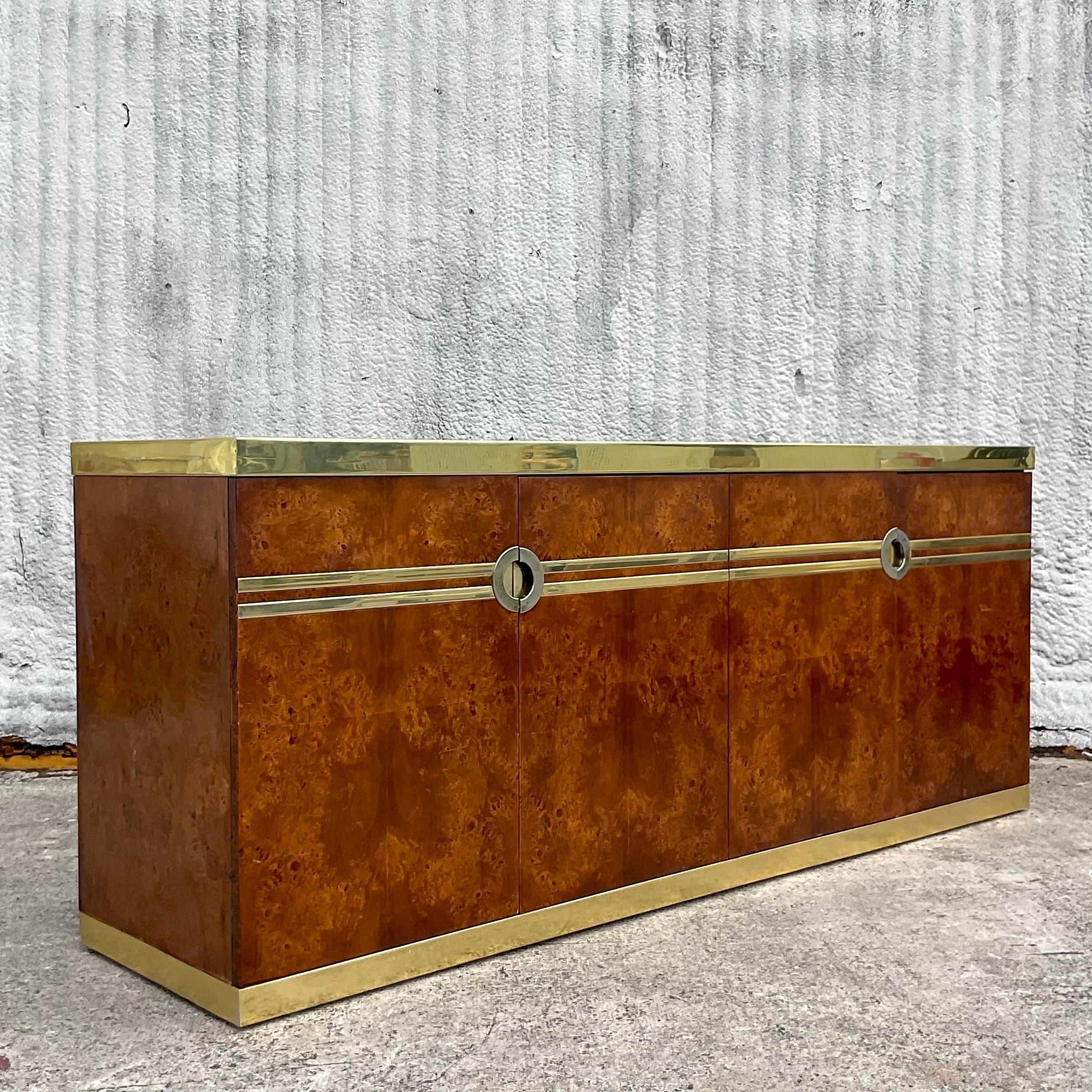 Infuse your space with mid-century French flair! This vintage boho Pierre Cardin burl wood and brass credenza epitomizes timeless sophistication and exceptional craftsmanship. With its sleek lines, rich textures, and elegant brass accents, this