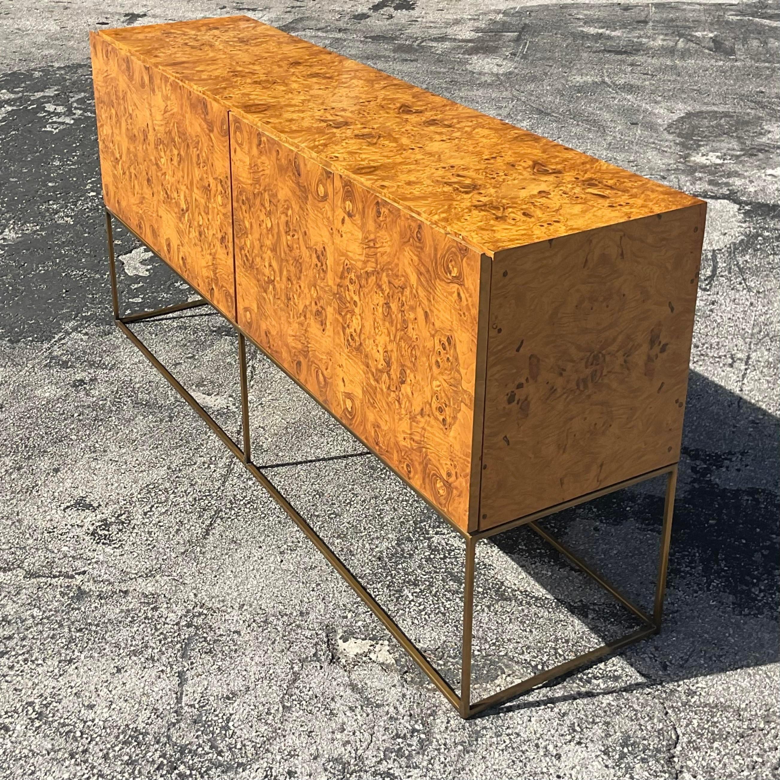 An exceptional vintage Boho credenza. Designed by the iconic Milo Baughma for Thayer Coggin. Beautiful book matched Burlwood cabinet on a tubular brass frame. Tagged inside the drawer. Acquired from a Palm Beach estate.