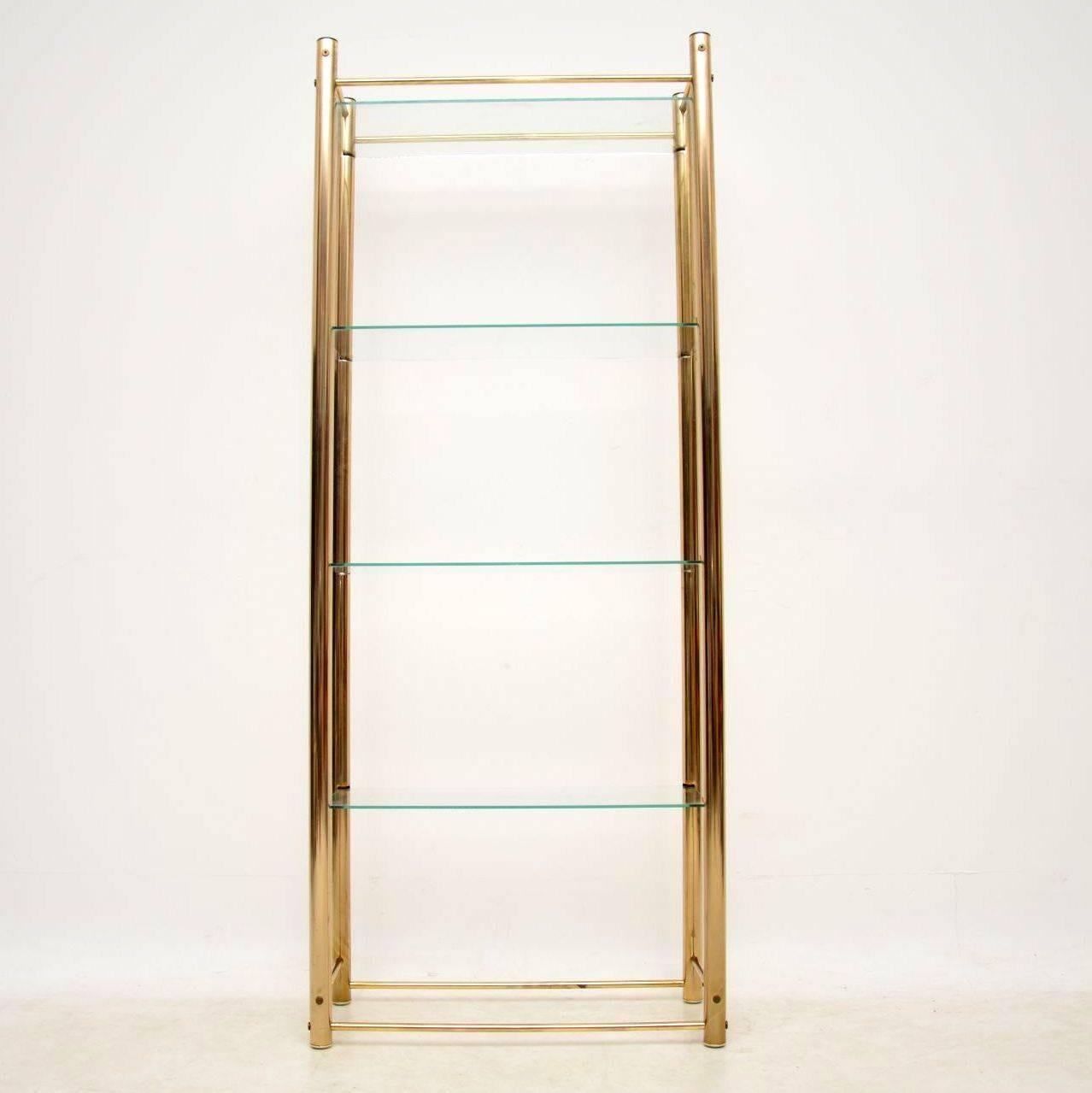 A stylish and useful vintage display stand in brass and glass, this dates from the 1960s-1970s. It’s in very good condition for it’s age, with only some very minor surface wear here and there on the brass frame. The clear glass shelves are in good