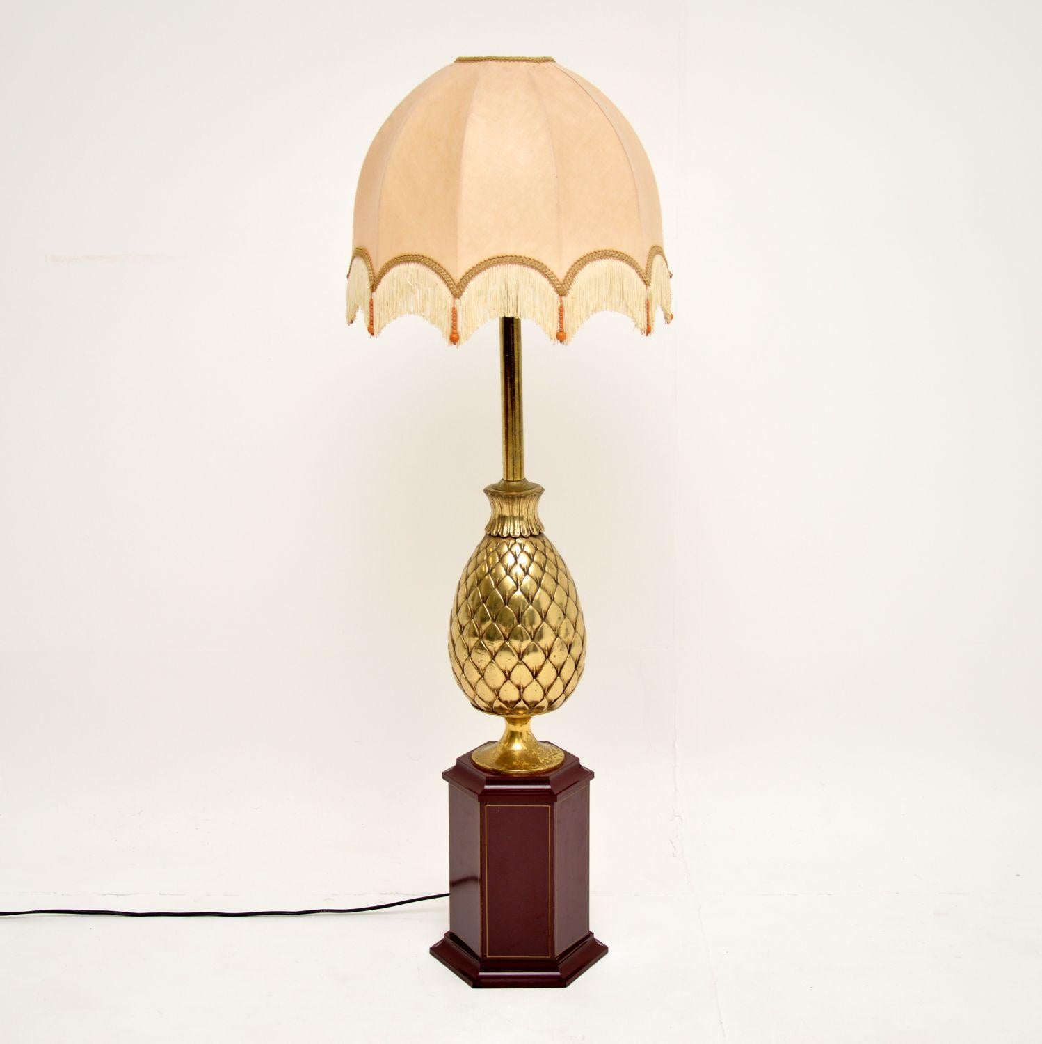 A stunning and very large vintage table lamp, this was made in France and dates from circa 1970s. It’s over one-meter-tall, so could be used as a table lamp or a floor lamp.

It has a beautiful pineapple shaped brass column, and sits on a lovely