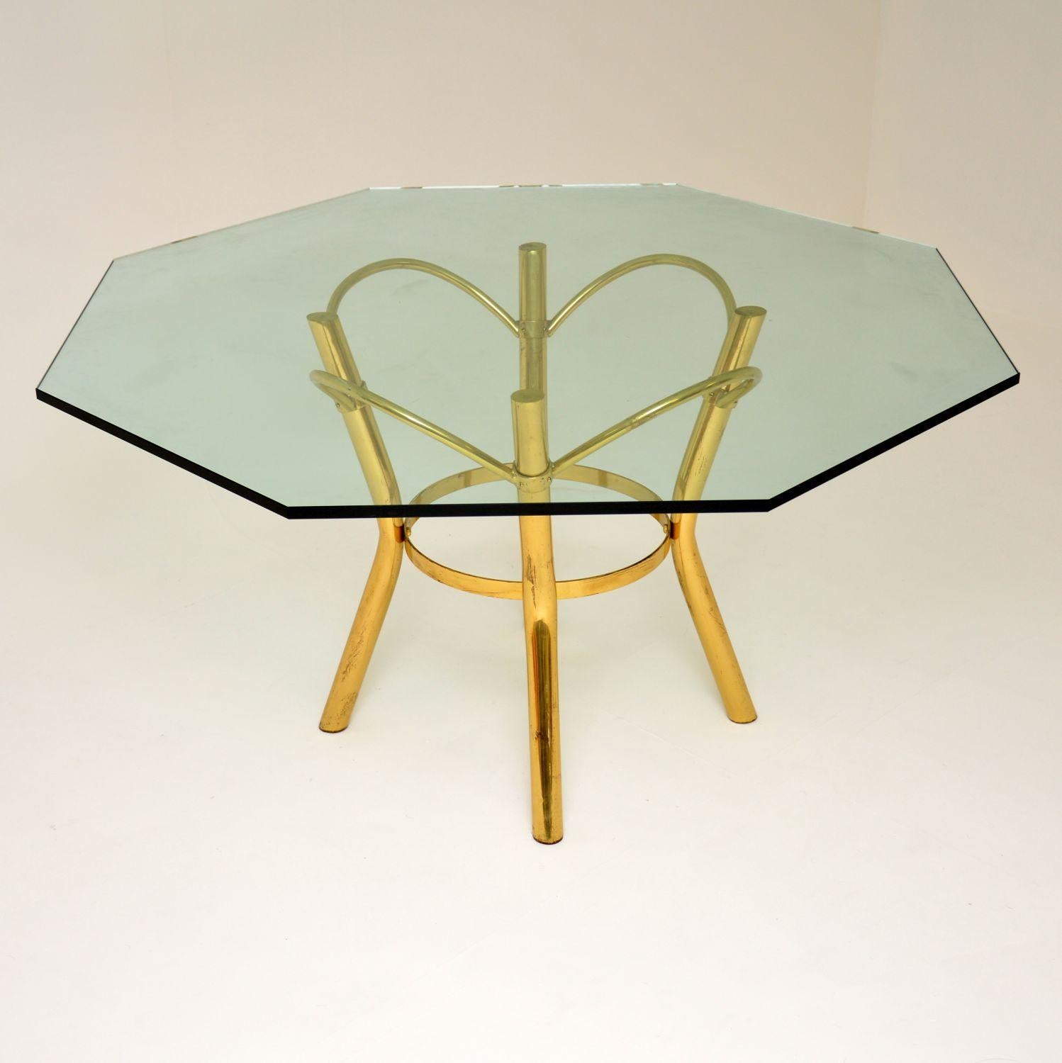 A stunning vintage dining table with a fantastic brass frame, and thick hexagonal glass top. This dates from the 1970s, it’s in excellent condition for its age. The top is very large and with eight sides, this table will comfortably seat eight