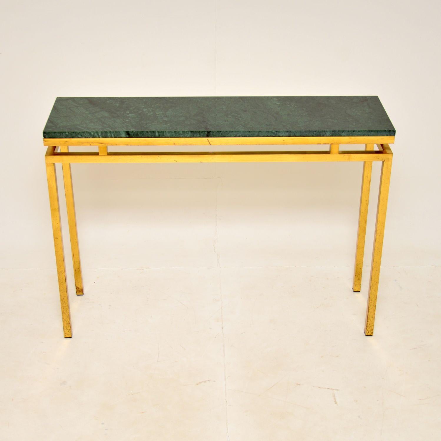 A fantastic vintage console table in solid brass and marble. This was made in France, it dates from the 1970’s.

It is of great quality with a very stylish design. The brass frame is nicely finished on both sides, so this can be used as a free