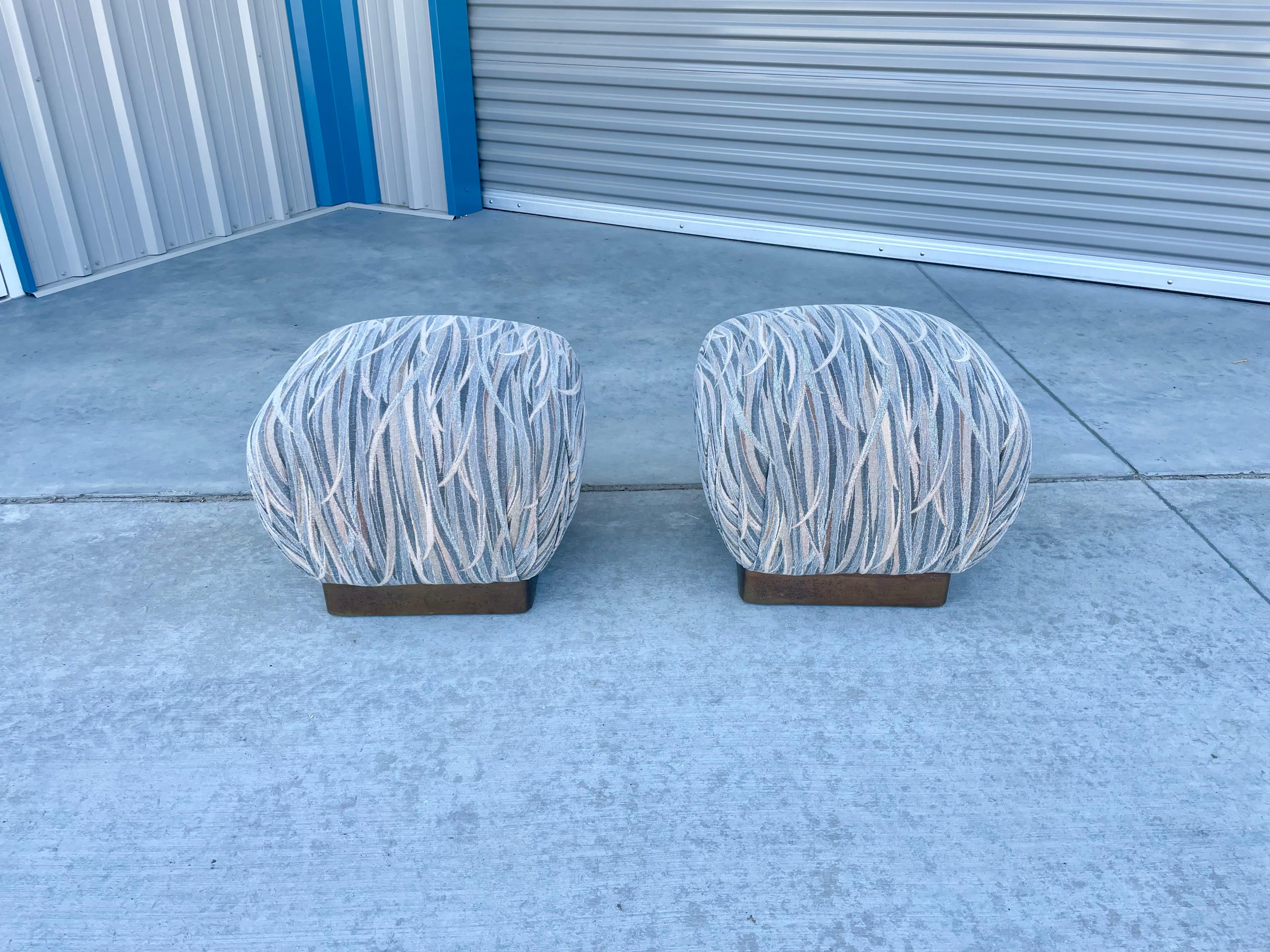 Wonderful pair of vintage brass poufs/ottomans designed by Marge Carson in the United States, circa 1970s. Each pouf features a brass base, and each cushion seems to have the design of a delicious souffle that is about to burst. This is ideal for