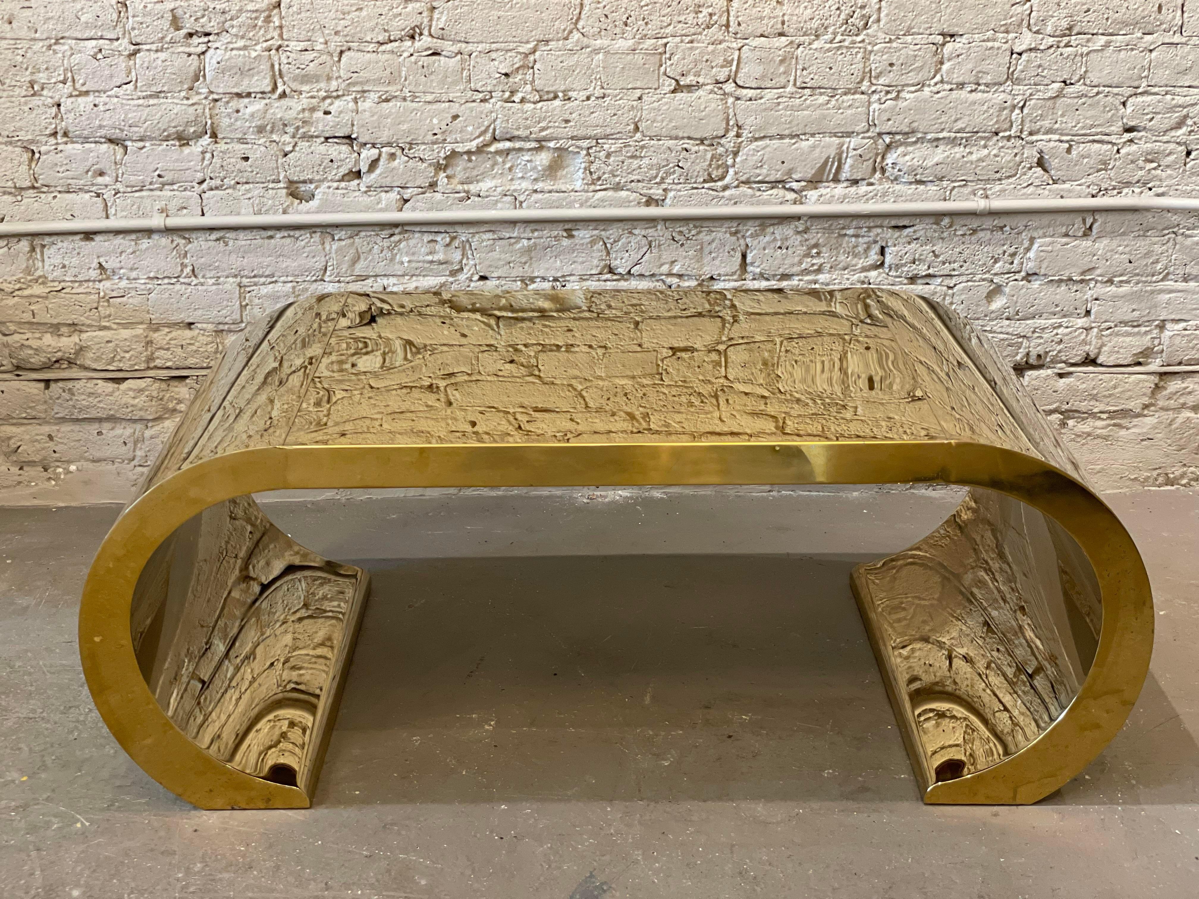 Have you ever seen a table like this? The beautiful shape and brass make this simply stunning. There are a few dings and scratch marks that come with age but overall this is in incredible condition and a statement piece for sure!