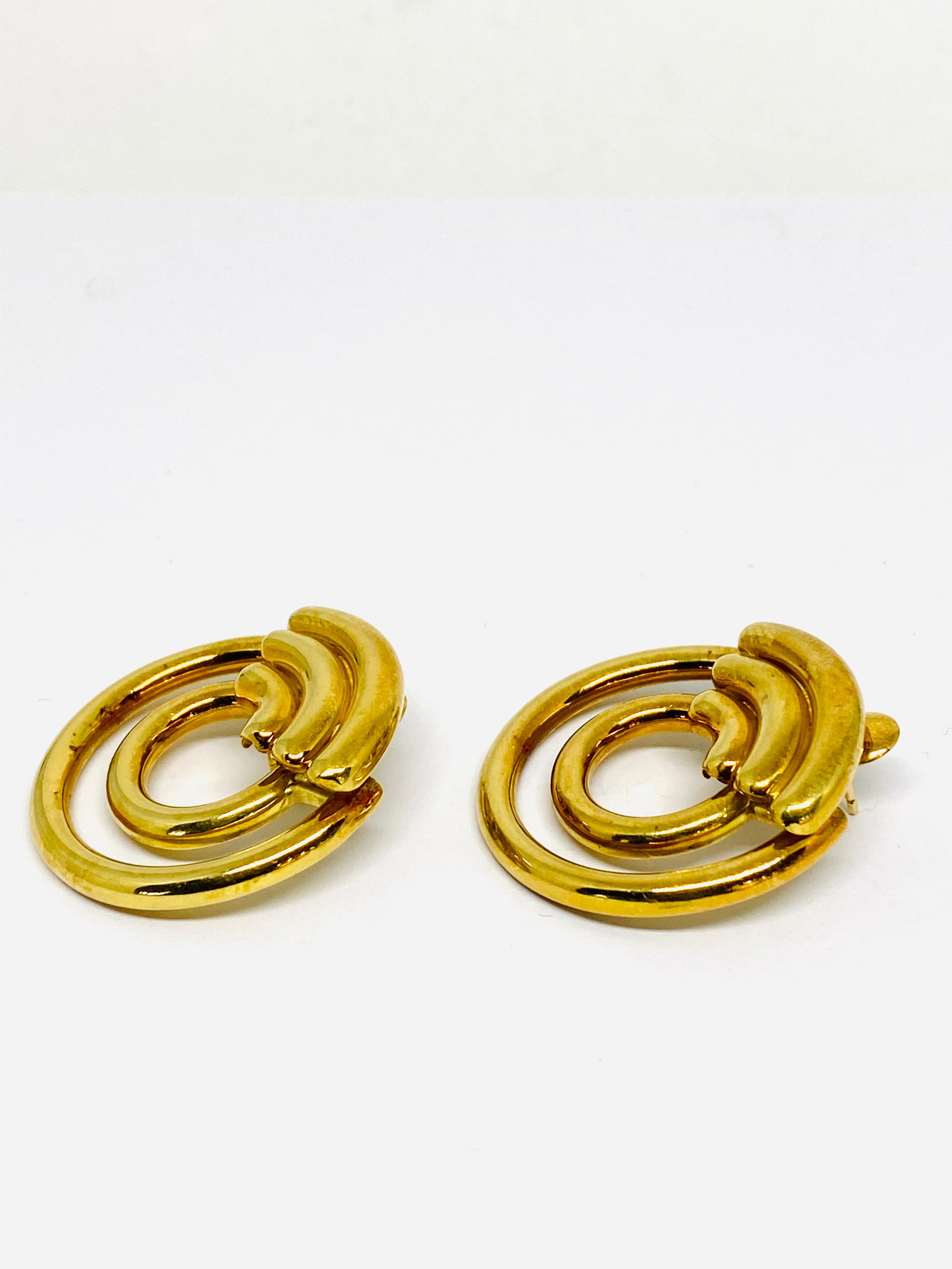 1970's Vintage CARTIER Aldo Cipullo 18K Yellow Gold Hoop Earrings

Product details:
Circa 1970
18K yellow gold double circle hoop style clip- on earrings w/ post
Signed Cartier Cipullo 18K and numbered 
Total weight is 38.0 grams 
Made in New York 
