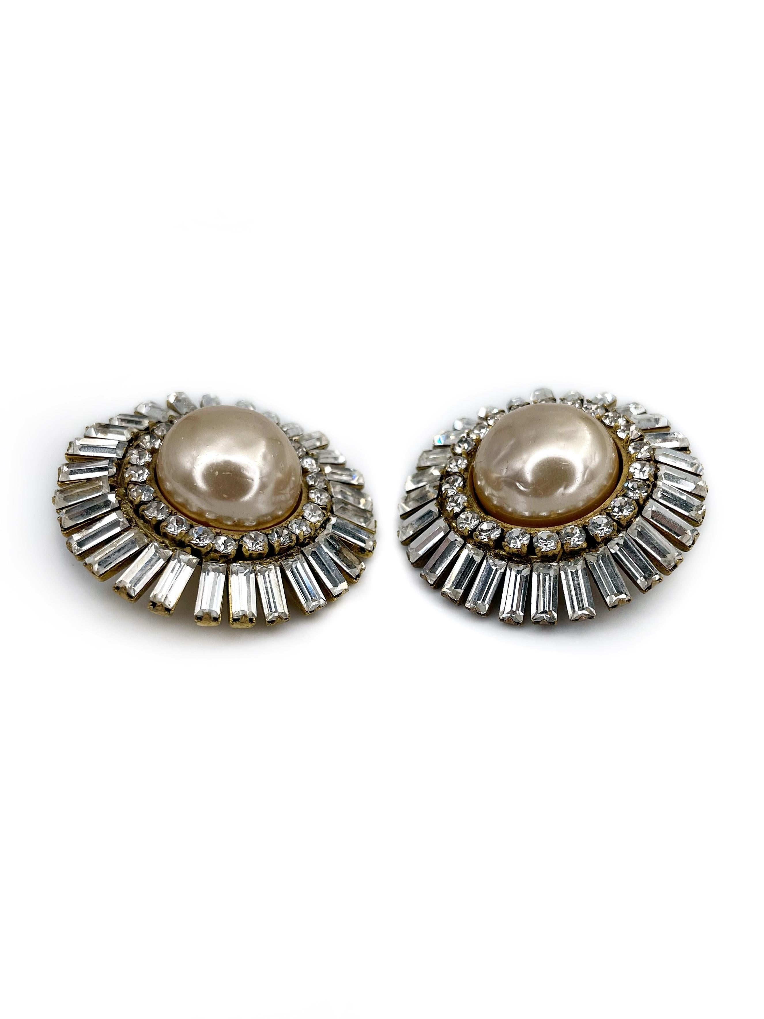 This is an amazing pair of large round clip on earrings designed by Chanel in 1970’s. It features creamy faux pearls and shiny clear crystals of mixed cut. 

One of the earrings back is rubbed off (can be see in photos). 

Signed: “ ©Chanel®. Made