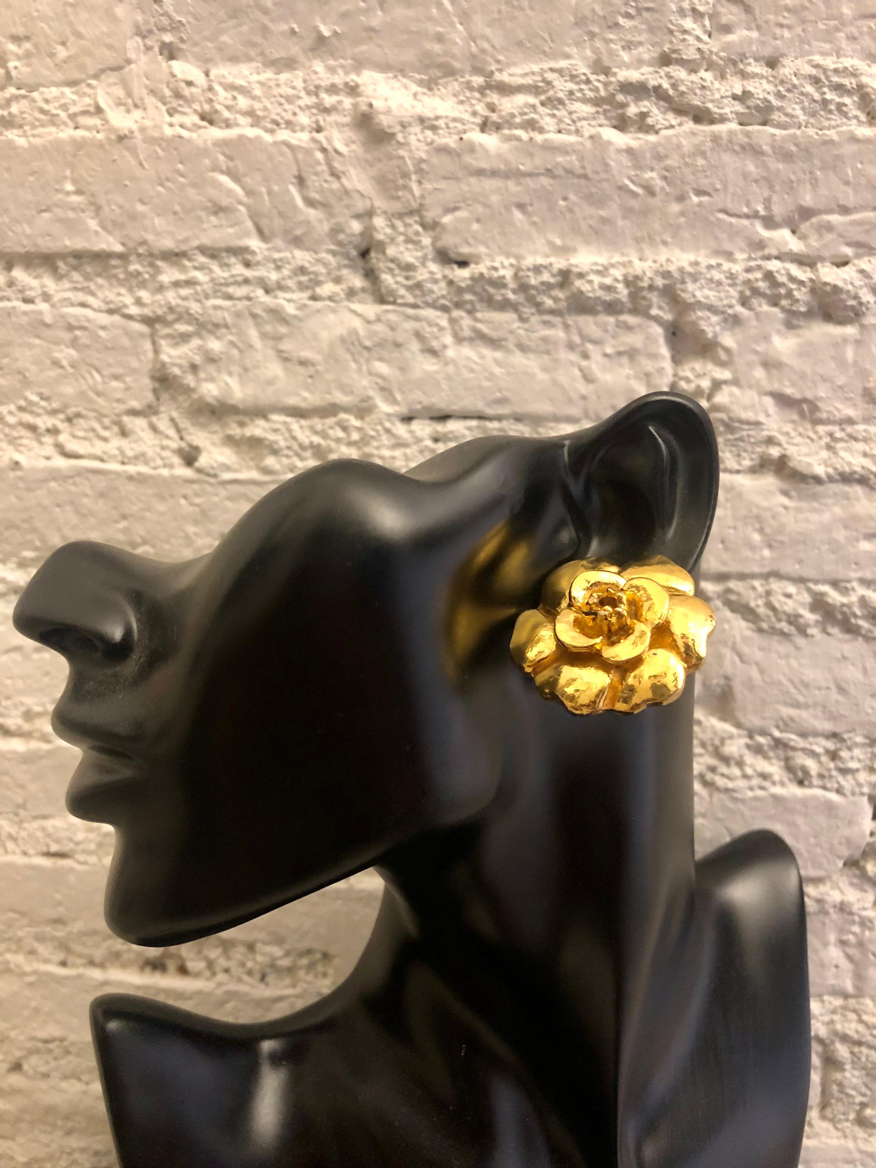These Vintage CHANEL clip-on earrings are beautifully crafted of gold plated metal in Chanel’s iconic camellia flower. They are truly vintage Chanel from the 1970s era. Stamped CHANEL made in France. Diameter measures approximately 3.5