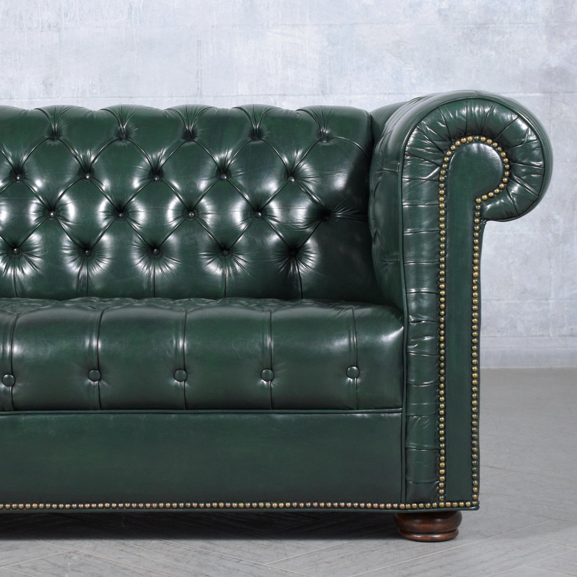 European 1970s Vintage Chesterfield Sofa: Emerald Green Leather with Elegant Carved Legs