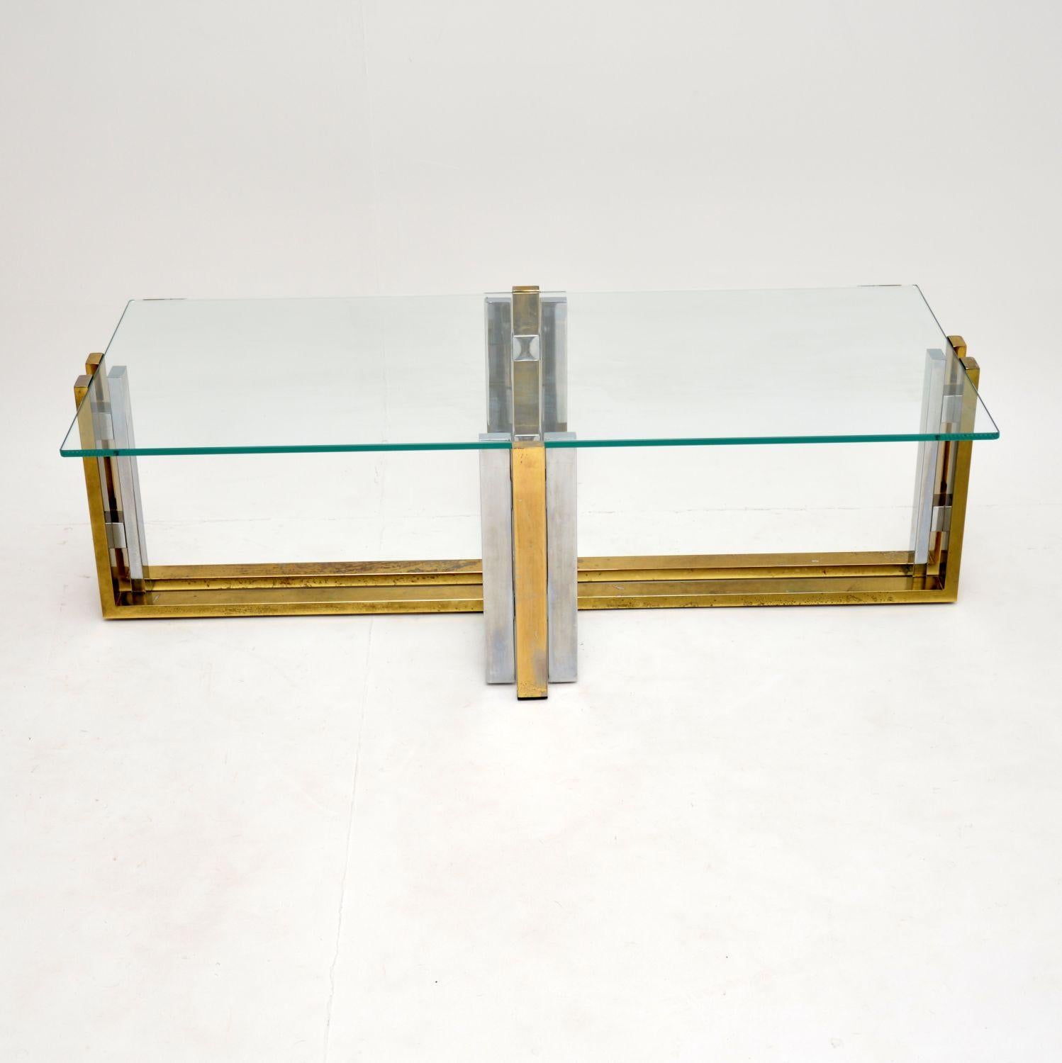 A stunning vintage coffee table dating from the 1970s. It has a beautifully designed frame made from brass and chrome plated steel.

We have had the toughened clear glass top newly made, so that is in perfect condition. The frame is clean, sturdy