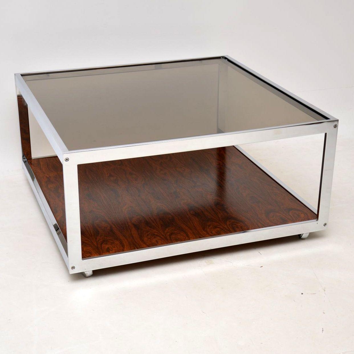 A stunning vintage coffee table made by MDA Howard Miller Associates, this dates from the 1970s. It has a lovely chrome frame, thick glass top and stunning wood base. The condition is excellent for its age, it is all very clean and structurally