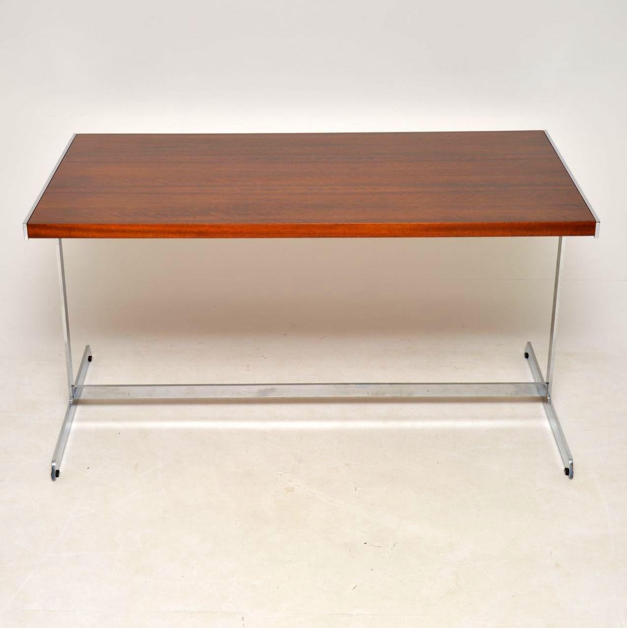 A stunning, top quality and very rare vintage desk or writing table, this was designed by Richard Young and was made by Merrow Associates in the early 1970s. It is extremely well made with a thick, chrome-plated steel frame and beautifully made wood