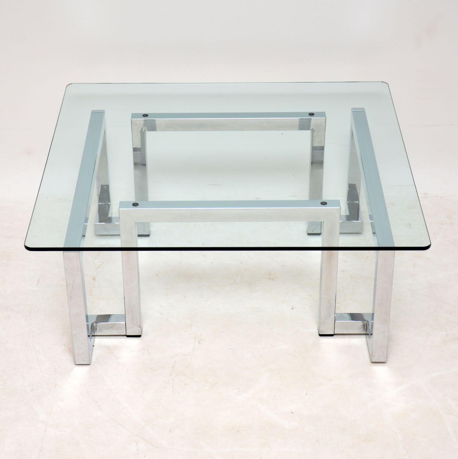 A stylish and very well made vintage coffee table, this was designed by Tim Bates and made by Pieff in the 1970s. It has a beautiful angular chrome frame, and thick toughened glass square top with rounded corners. It is in superb condition for its