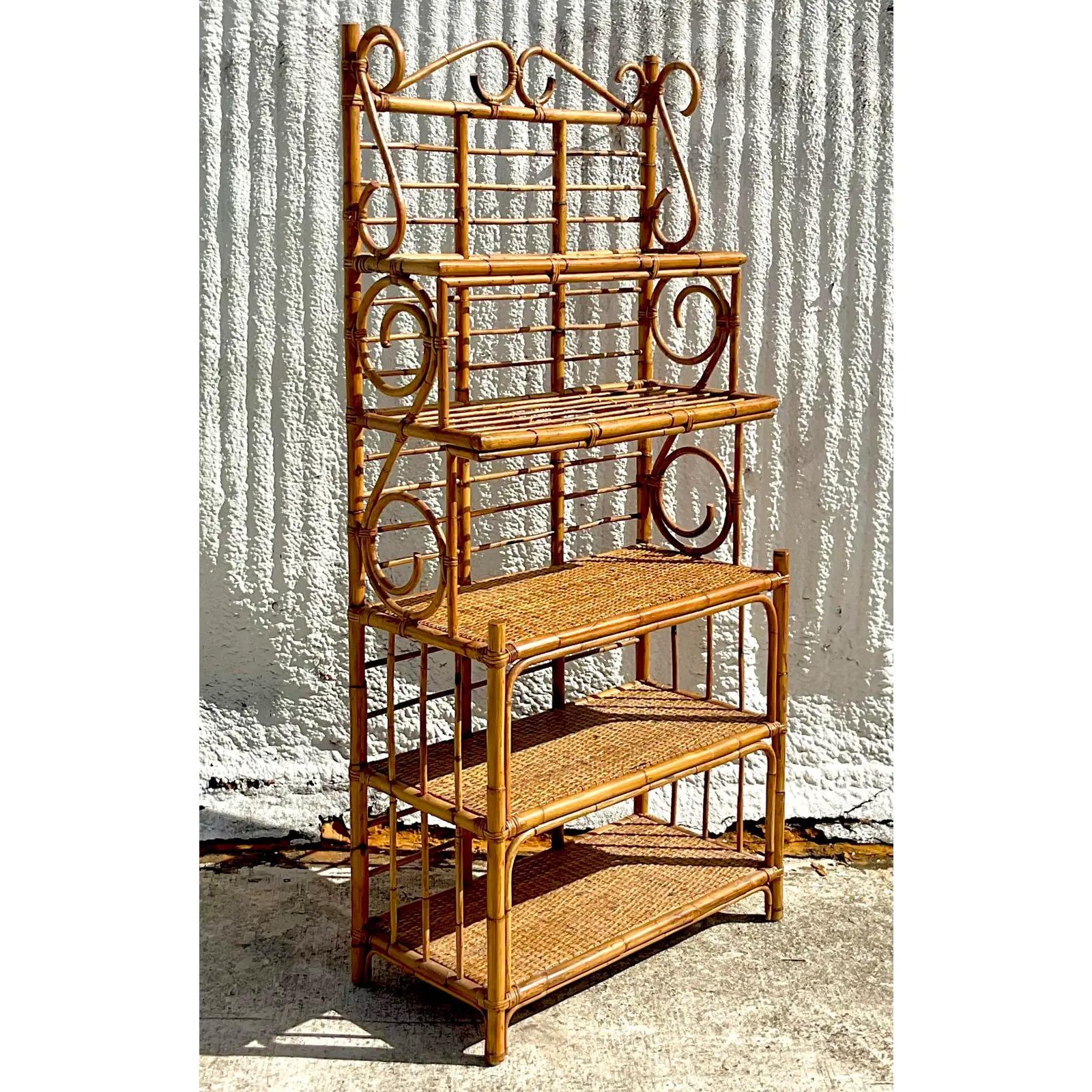 A fabulous vintage Coastal Bakers Rack. Be audio tortoise shell rattan with inset woven rattan shelves. Acquired from a Palm Beach estate.