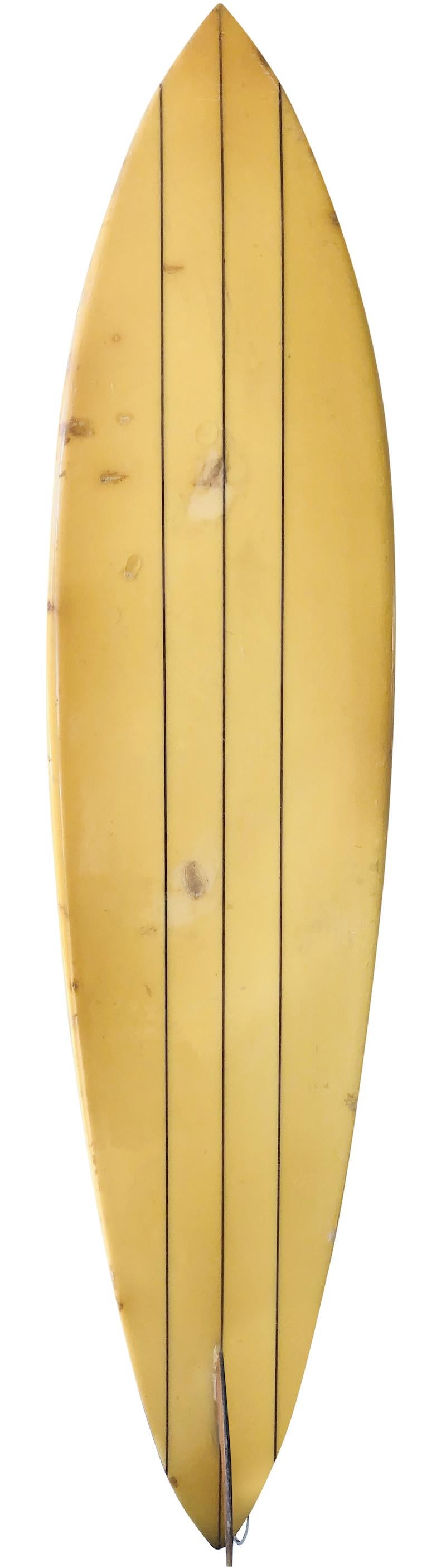 Mid-1970s Dick Brewer shaped single fin surfboard. Features a pintail shape with redwood triple stringer and glassed on redwood single fin. This vintage surfboard remains in all original condition.

Dick Brewer is a world famous Pioneer surfboard