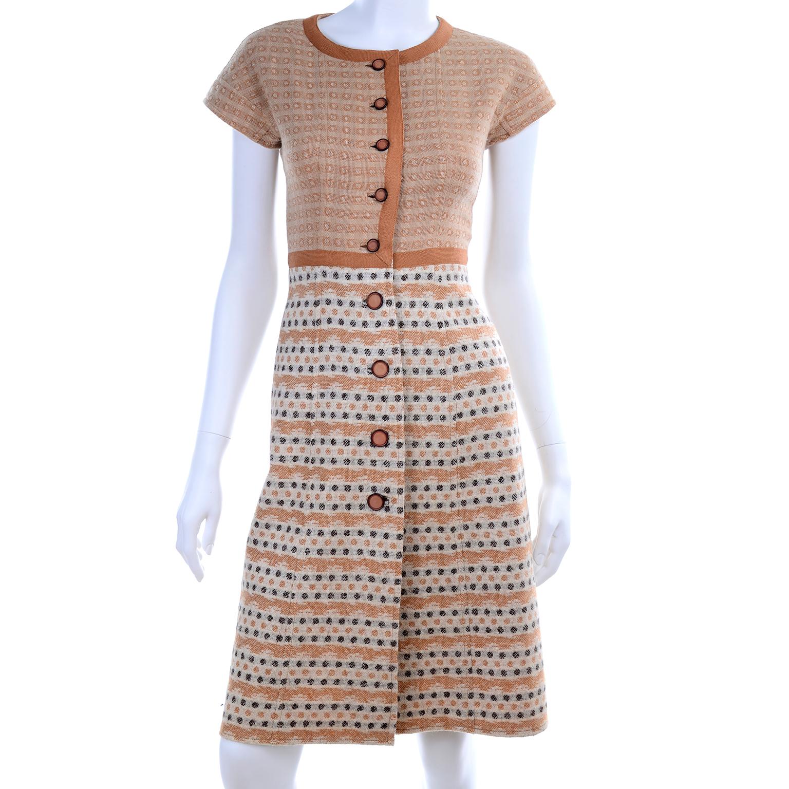 This is a rare wool knit vintage dress and jacket suit from Emanuel Ungaro Parallele from the 1970's.  The outfit includes a short sleeve dress that buttons down the center front and a jacket with pockets and a fabric belt.  We love the orange and
