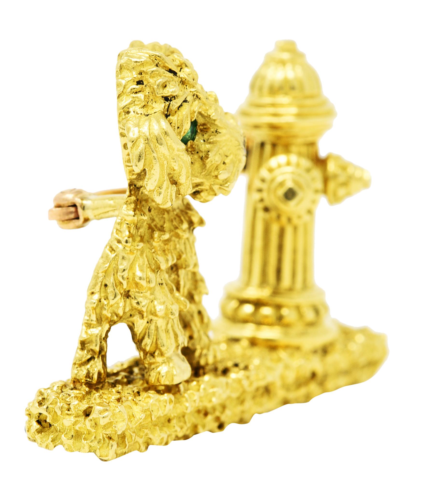 Brooch is designed as texturous dog sitting next to highly rendered fire hydrant

Accented by flush set round cut emerald eyes - transparent and bright green

With a flush set round cut diamond nose - eye clean and bright

Stones weigh collectively