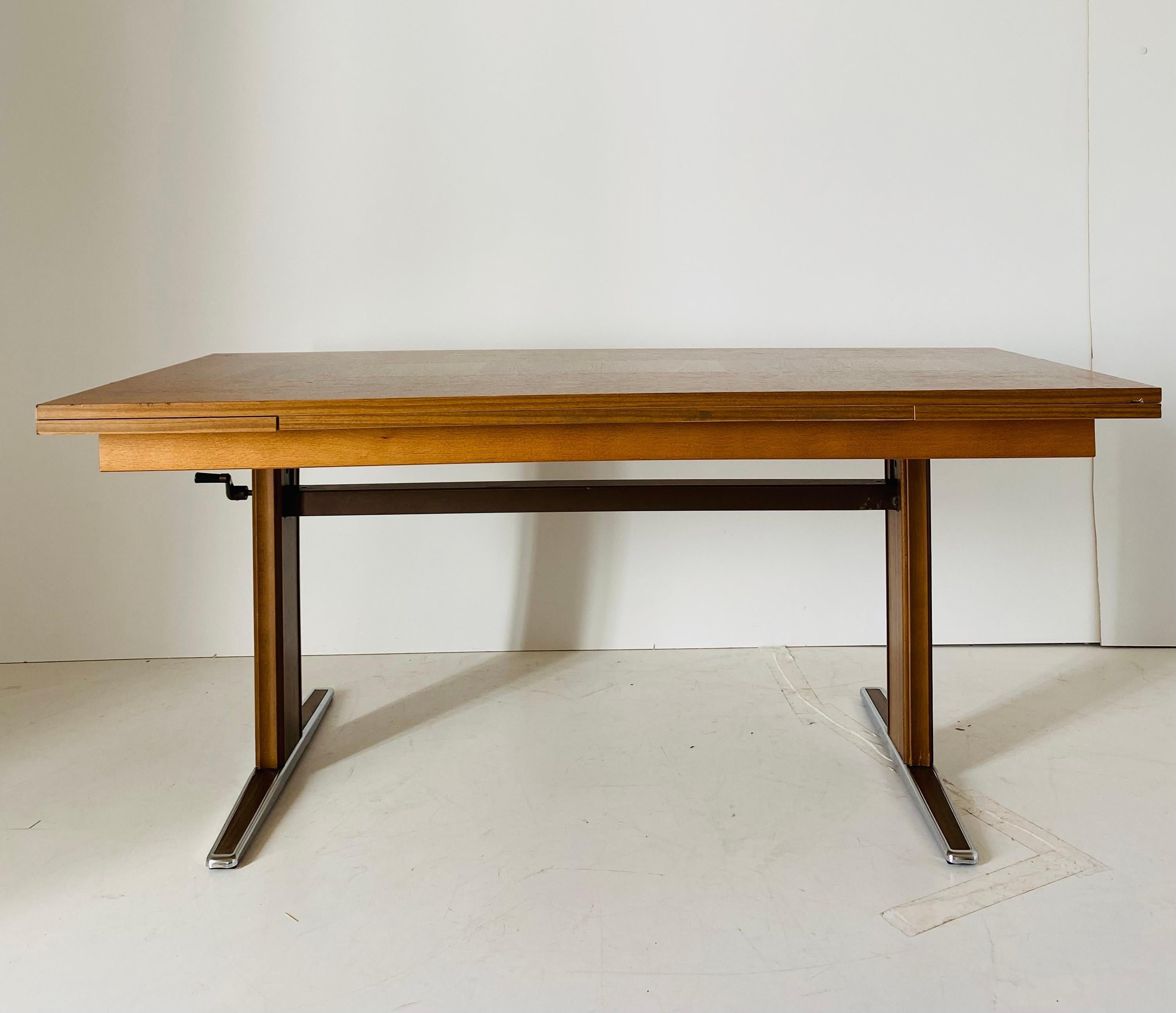 Vintage extendible coffee table, Italy 1970s.

A rare extendible rectangular coffee table with chromed feet. Italian mid-century style piece of vintage design. 
The table is made of a wood venereed top with chance both to extend it on the sides