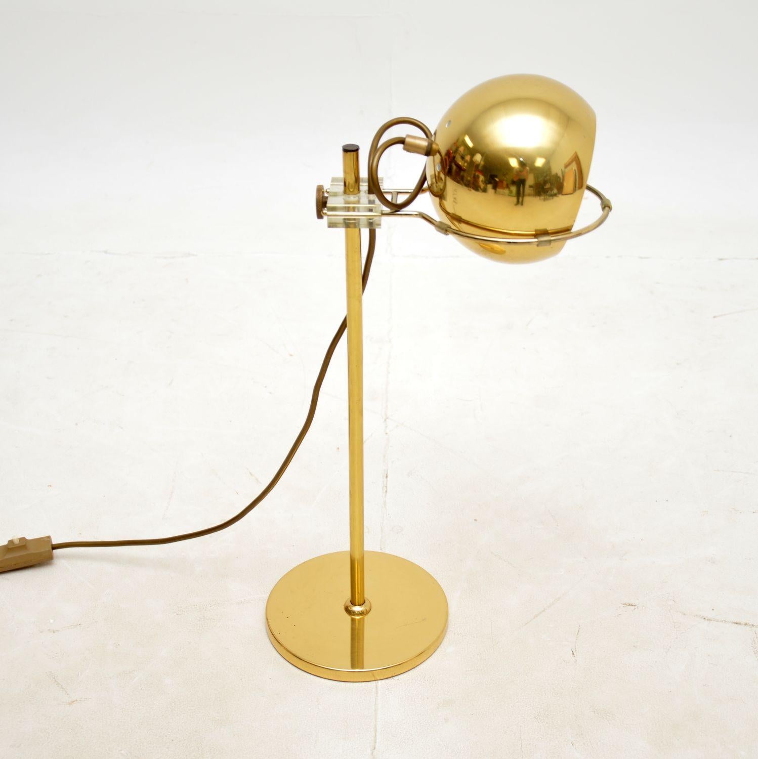 A very stylish and well made vintage desk lamp in brass. This was made in France, it dates from around the 1970s.
It has a fantastic design, the round lamp shade rests loosely in an adjustable basket that can be raised and lowered along the central