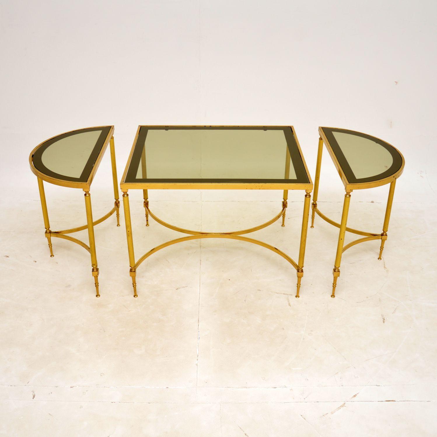 A superb vintage French brass and glass set of three tables / cofee table, dating from the 1970’s.

The quality is excellent and they are beautifully designed. This set consists of a larger rectangular centre table, with two smaller semi circular