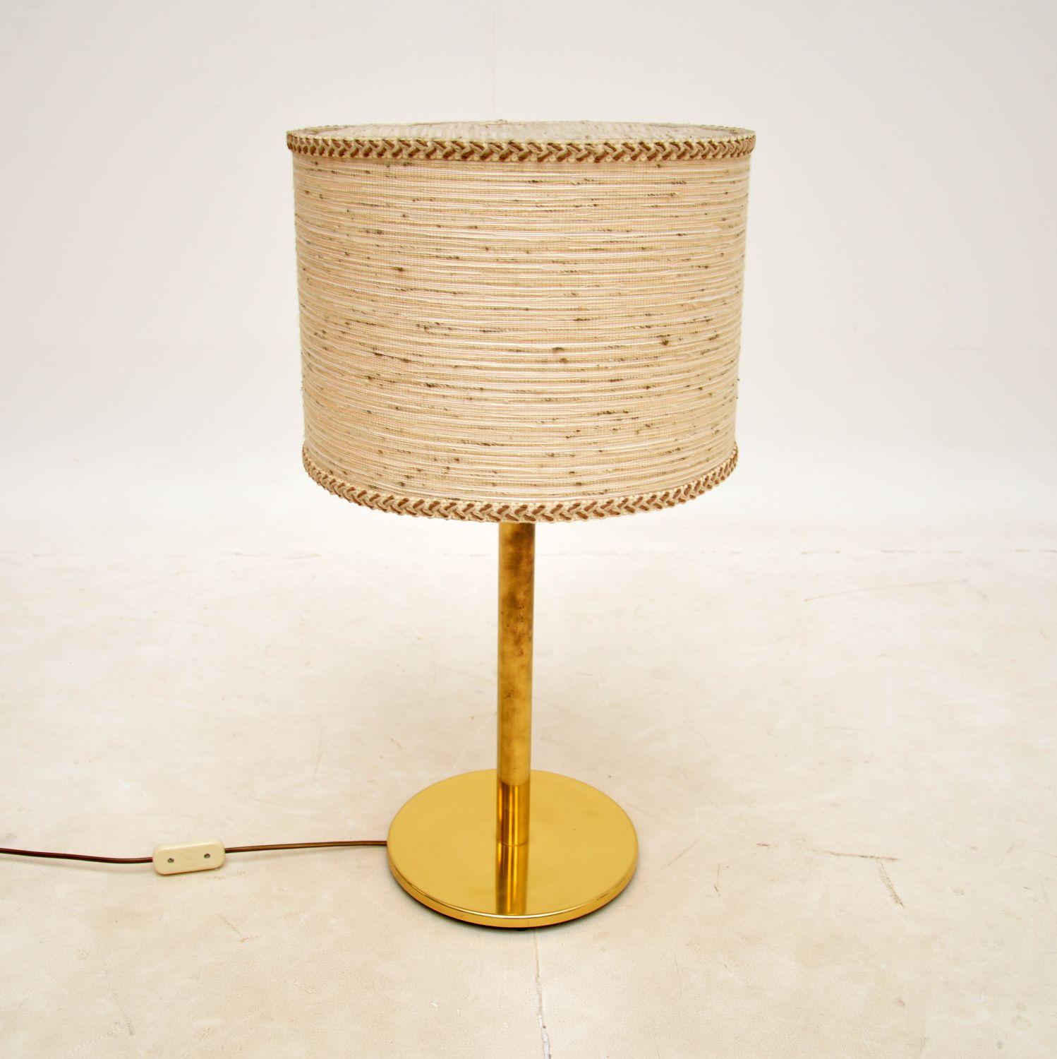 A large and impressive vintage table lamp in solid brass. This was recently imported from France, it dates from around the 1970’s.

It is of superb quality, with a thick and sturdy base. The shade is original, it appears to be a woven textured
