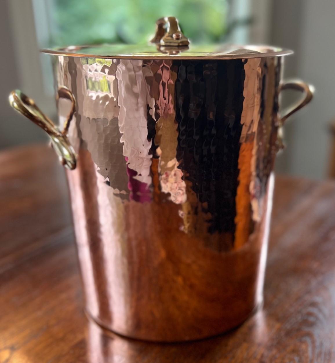 1970's vintage French hammered copper and tin lined stockpot with lid and polished brass hand grips.

Sur La Table is a kitchenware store in the US that started business in Seattle, Washington, in 1972.  The stamps on this pot feature the store’s