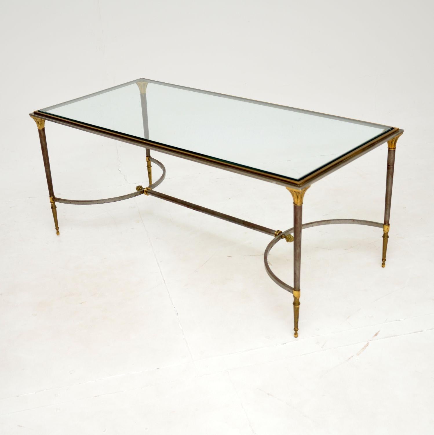 A stunning vintage coffee table of magnificent quality. This was made in France, it dates from around the 1970’s.

The frame is steel with a brass rim around the top and gold leaf embellishments on the base. It has beautiful details like acorn