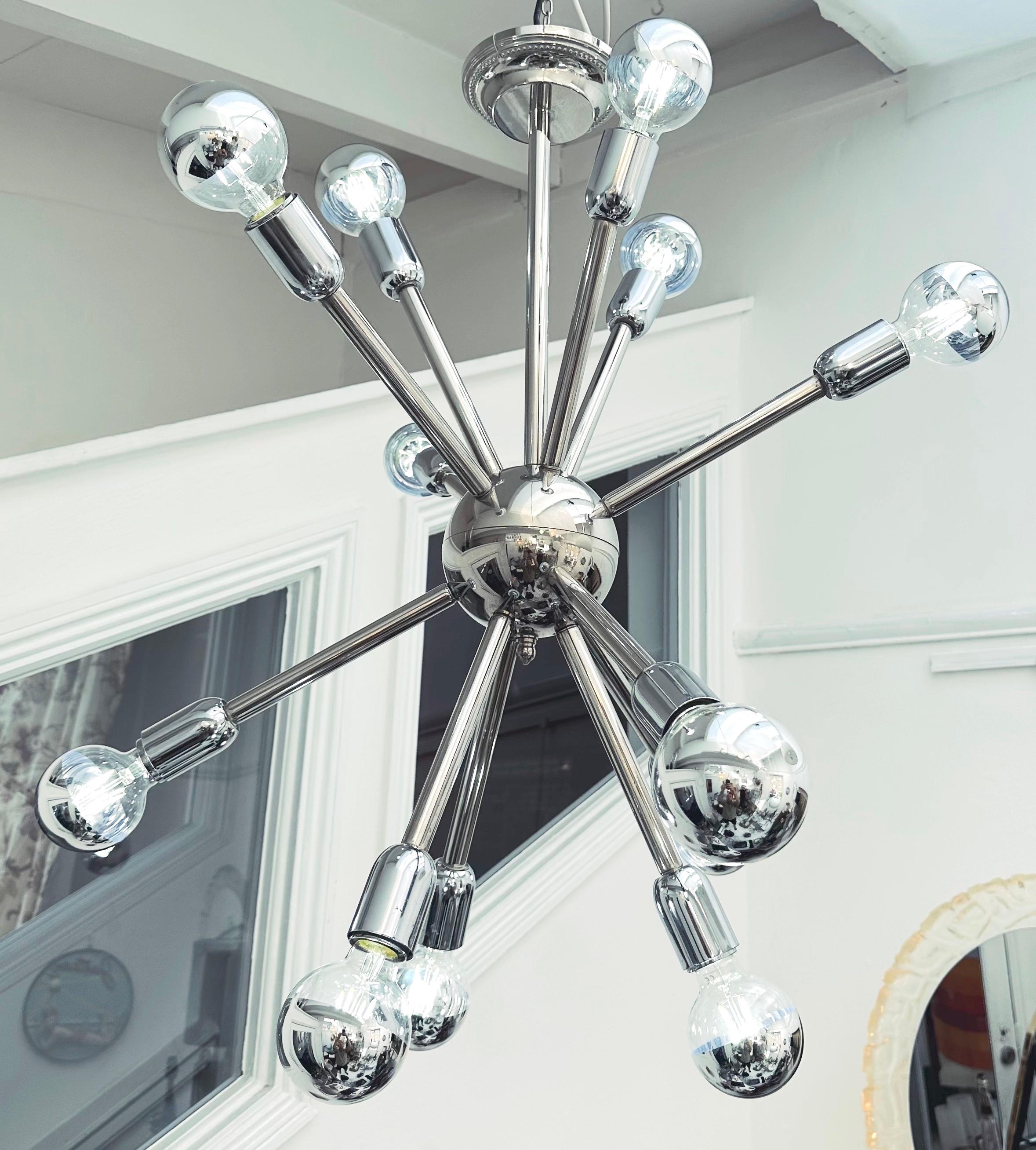 1970s German vintage mid century chrome eleven arm sputnik ceiling light. Each of the chrome-plated steel arms is fixed to a sphere which splits in two to allow access to the internal workings of the light. A further arm connects the sphere to the