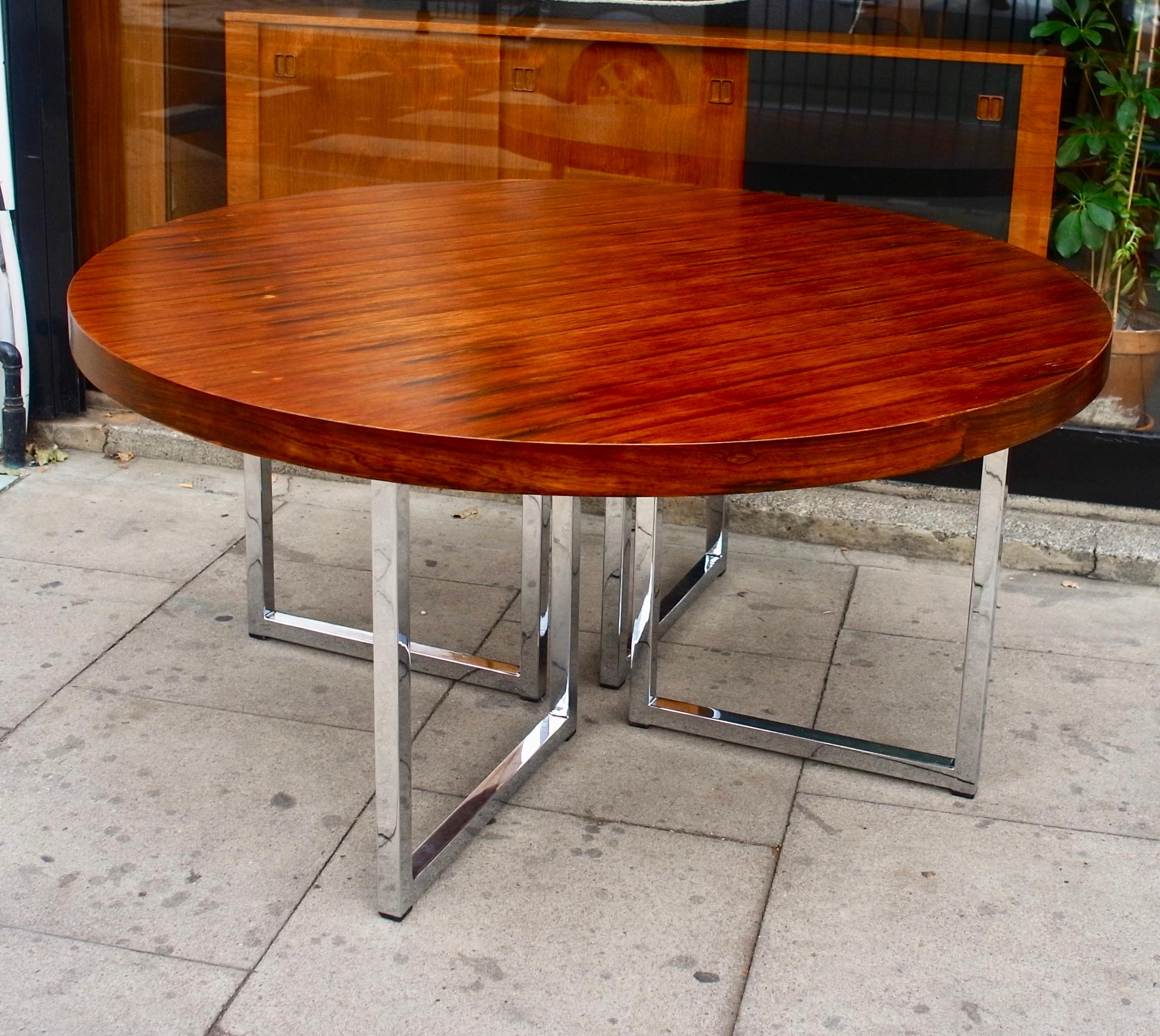 A very beautiful, rare and stylish vintage round 1970s dining table in Rosewood set on square tubular chromed legs. Manufactured by Gordon russell ltd, and designed by Ray Leigh and Trevor Chinn in 1976. This British designed dining table is large