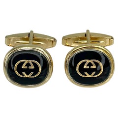 1970s Vintage Gucci Gold Tone Black Enamel GG Motif Oval Cufflinks