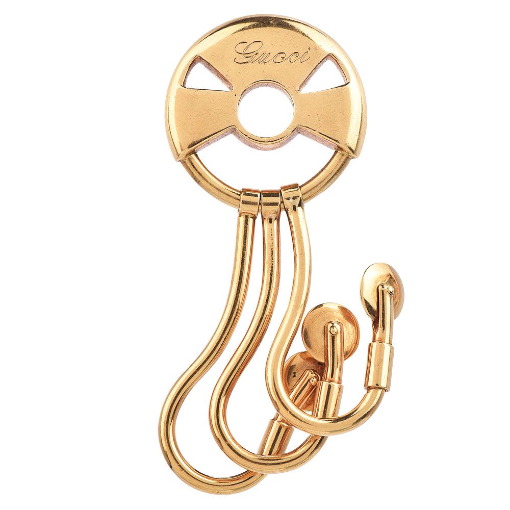 An exquisite example of Gucci’s Unique design

features three drop-down hooks for 18k gold key sets and has a total approx. weight of 38.0 grams.

Crafted in Solid 18K yellow gold, this Vintage 1970's piece presents the distinctive Gucci Hallmark
