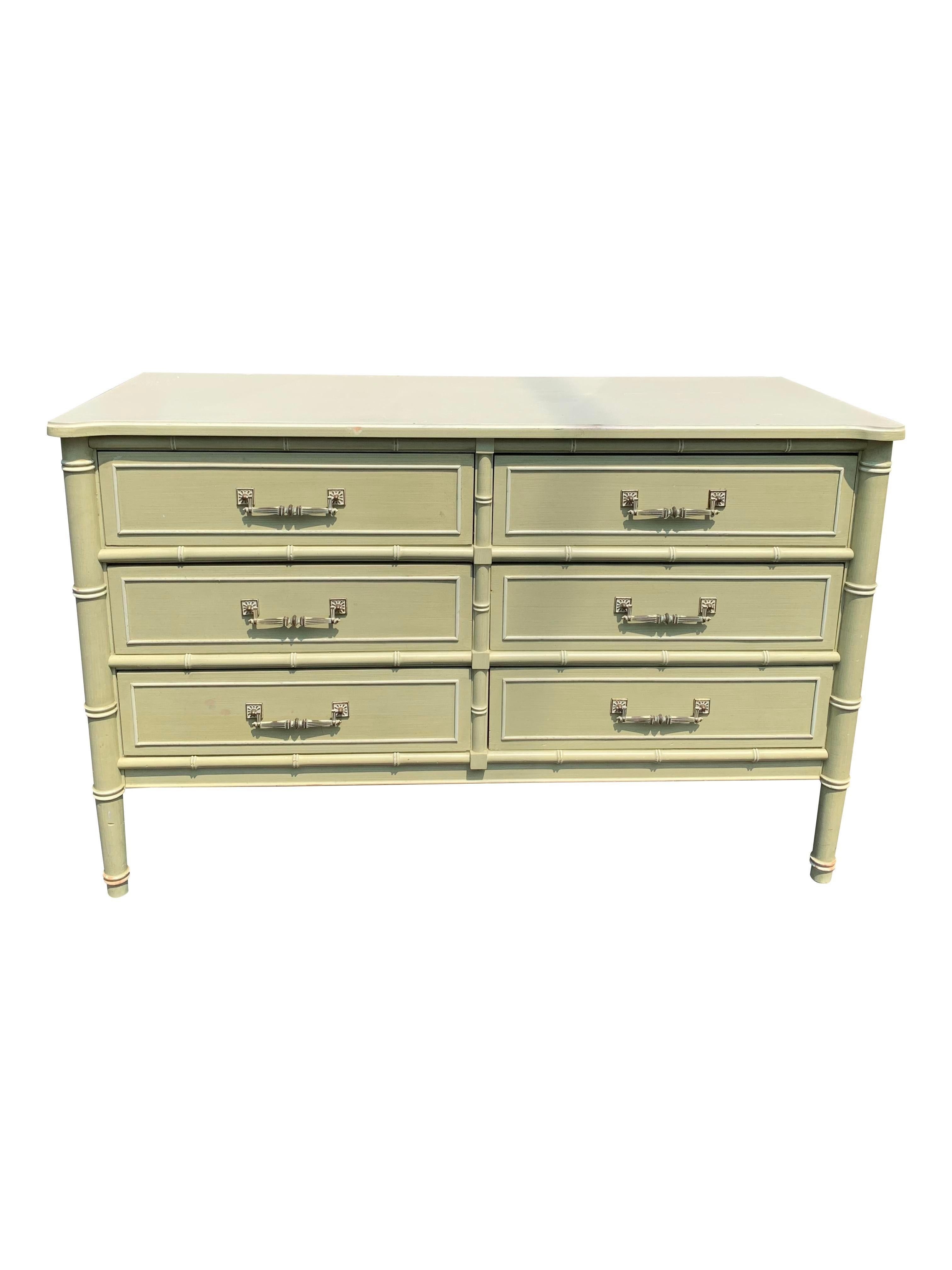 Vintage Henry Link Faux Bamboo Dresser or Credenza Cabinet.

Add a touch of coastal bohemian chic to your home with this stunning vintage Henry Link faux bamboo dresser or credenza cabinet. This popular 