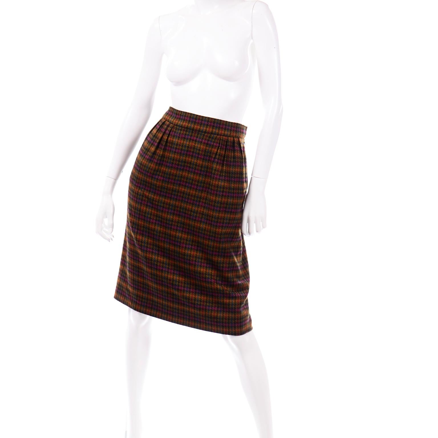 This fall/winter late 1970's Hermès houndstooth plaid wool skirt is in beautiful shades of olive green, navy, teal, magenta, orange, red, black, and brown. The bright colors in this houndstooth print are muted and understated, so they blend well