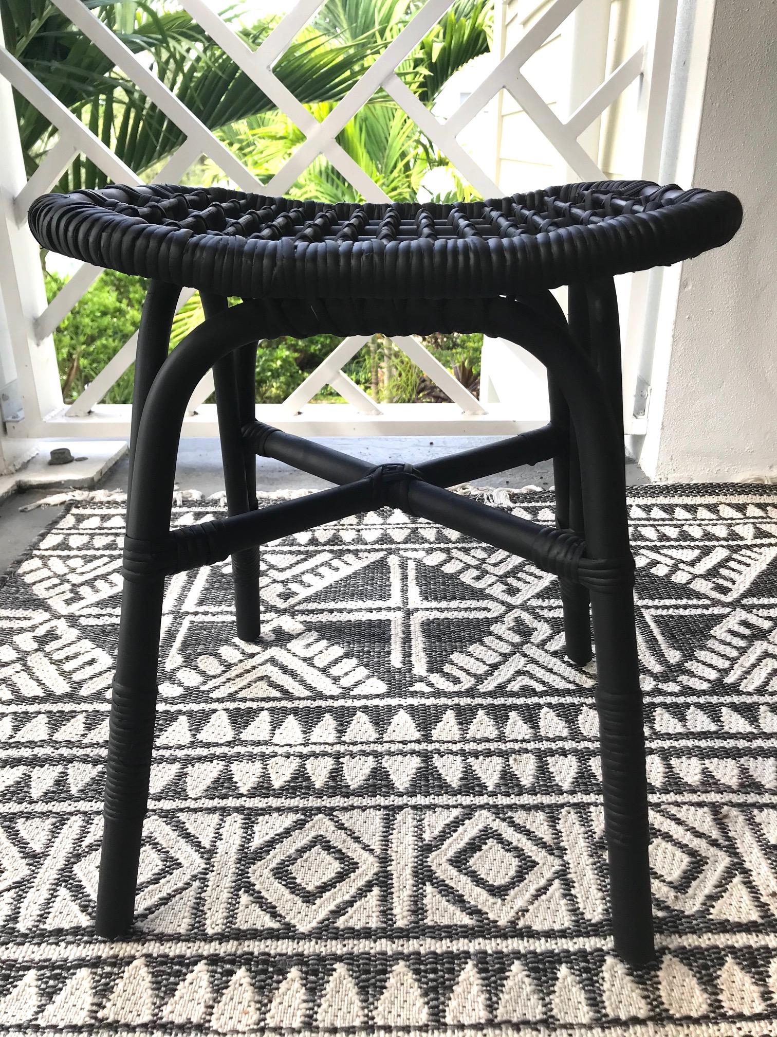 Vintage Indonesian handcrafted stool and ottoman made of sustainable bamboo and knotted rattan. Hand painted in black with a satin matte finish. The stool mixes the best of artisanal craftsmanship with Mid-Century Modern design. It features a curved