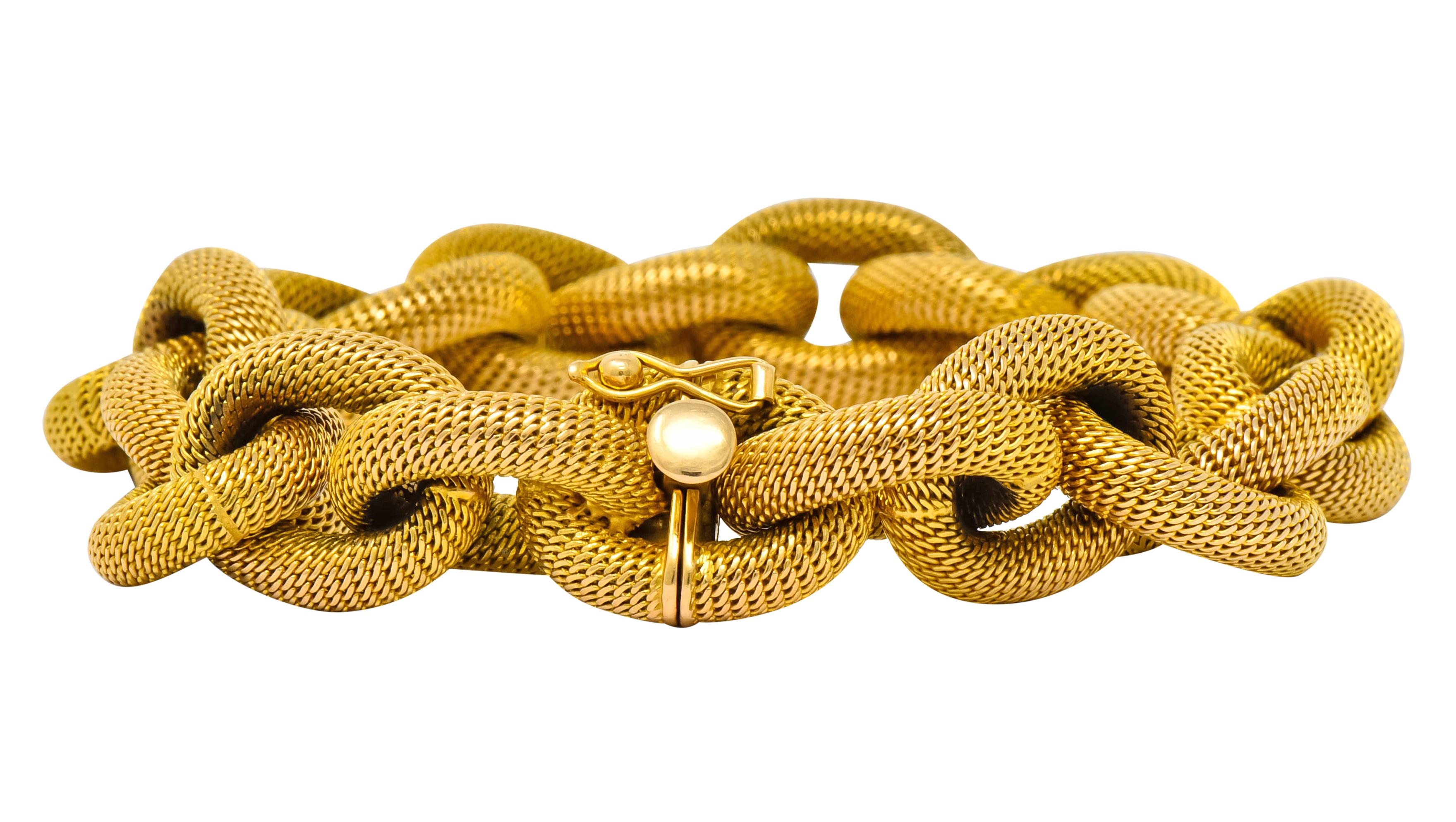 Link style bracelet comprised of large, hollow, mesh links

With a matte gold textured finish

Completed by concealed clasp and figure eight safety

With maker's mark and assay mark for Verona Italy

Stamped 750 for 18 karat gold

Circa