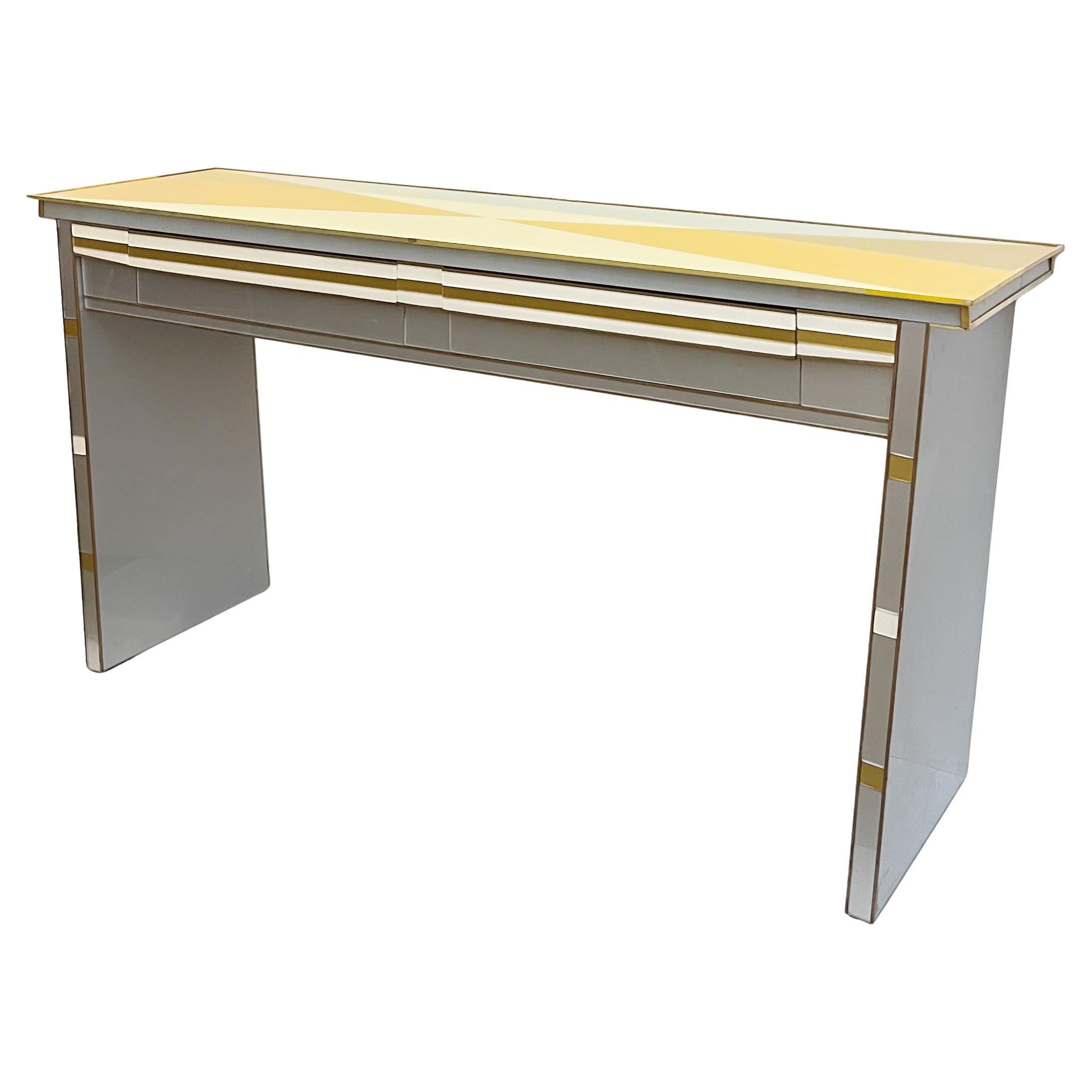 1970s one-of-a-kind, bespoke Italian console with a unique, sleek Art Deco style design featuring Hollywood Regency glamour, masterfully balancing geometry and distinction. This statement piece is fitted with 2 stepped drawers in the frieze, edged