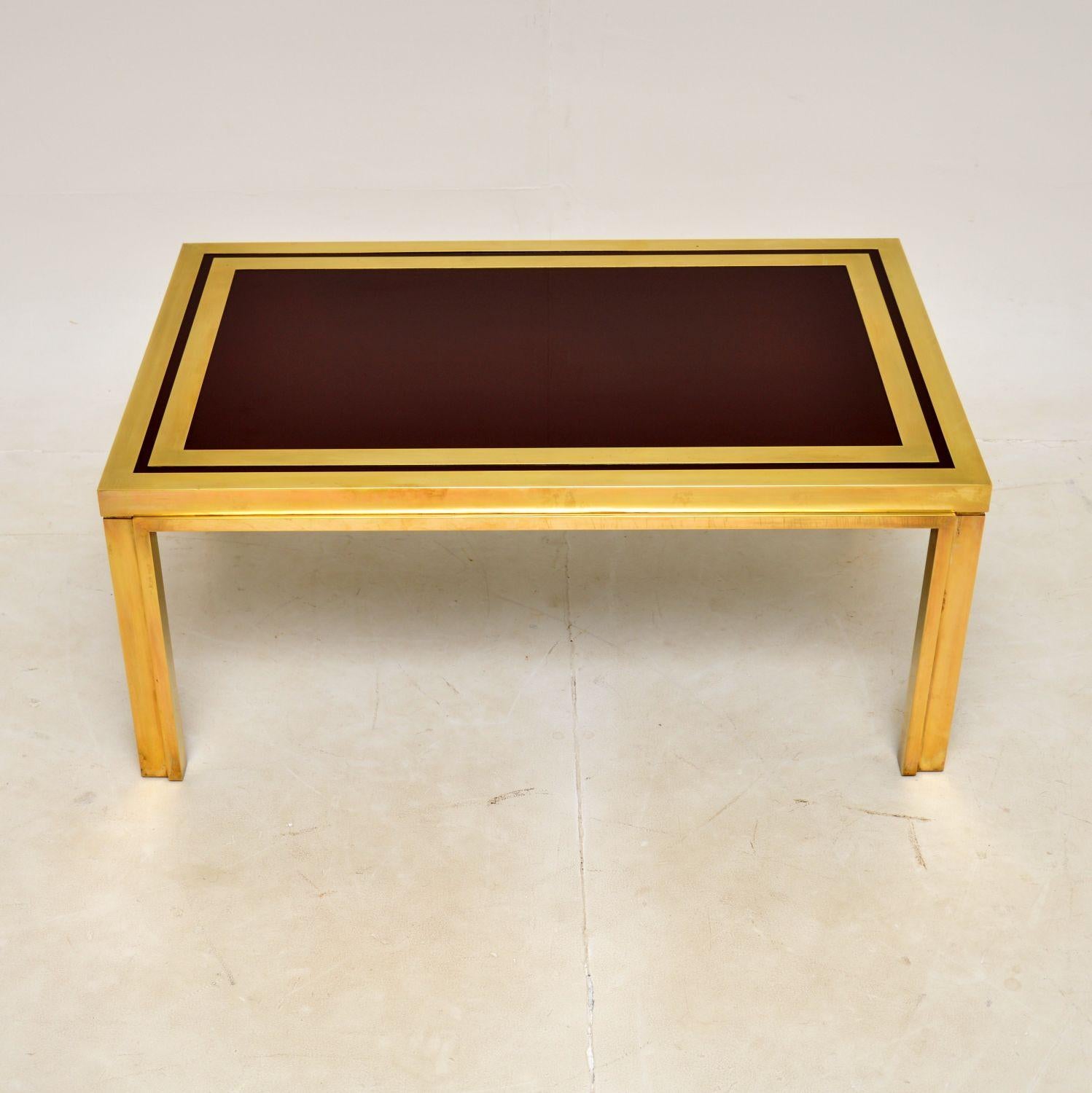 A stunning vintage Italian coffee table in brass with a burgundy coloured lacquered top. This dates from the 1970s.

The quality is outstanding and this has an absolutely gorgeous design, it looks amazing from all angles.

We have given the brass