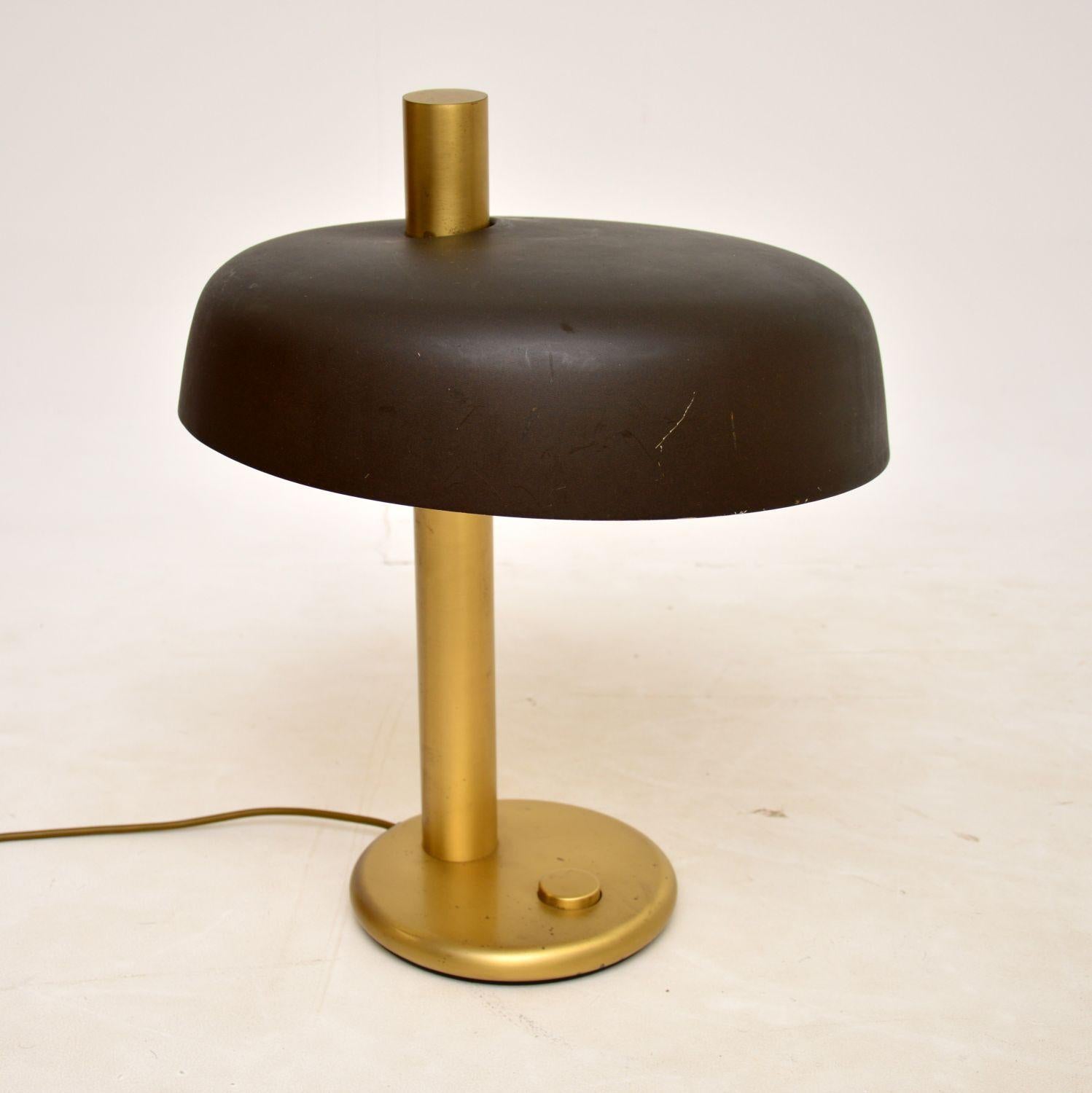 A very stylish and unusual vintage desk lamp in brass with a dark metal shade. This was recently imported from Italy, it dates from around the 1970s.

The quality is fantastic, with a very bold and interesting design. The shade is fixed and is set