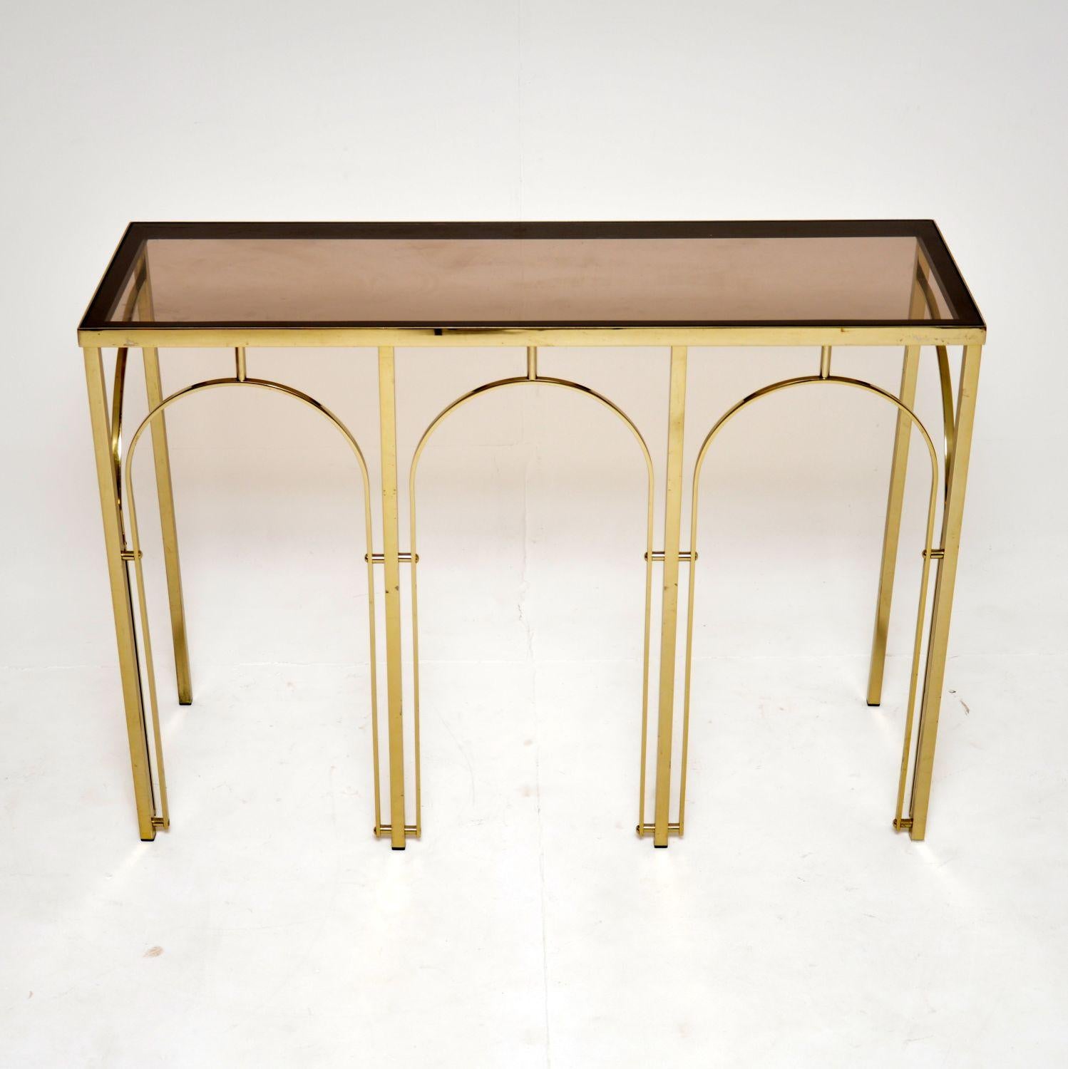 A very smart and stylish 1970’s vintage Italian glass top brass console table.

The quality is excellent, this is a useful size with a very elegant design. The inset glass top is slightly tinted and is removable.

The overall condition is excellent