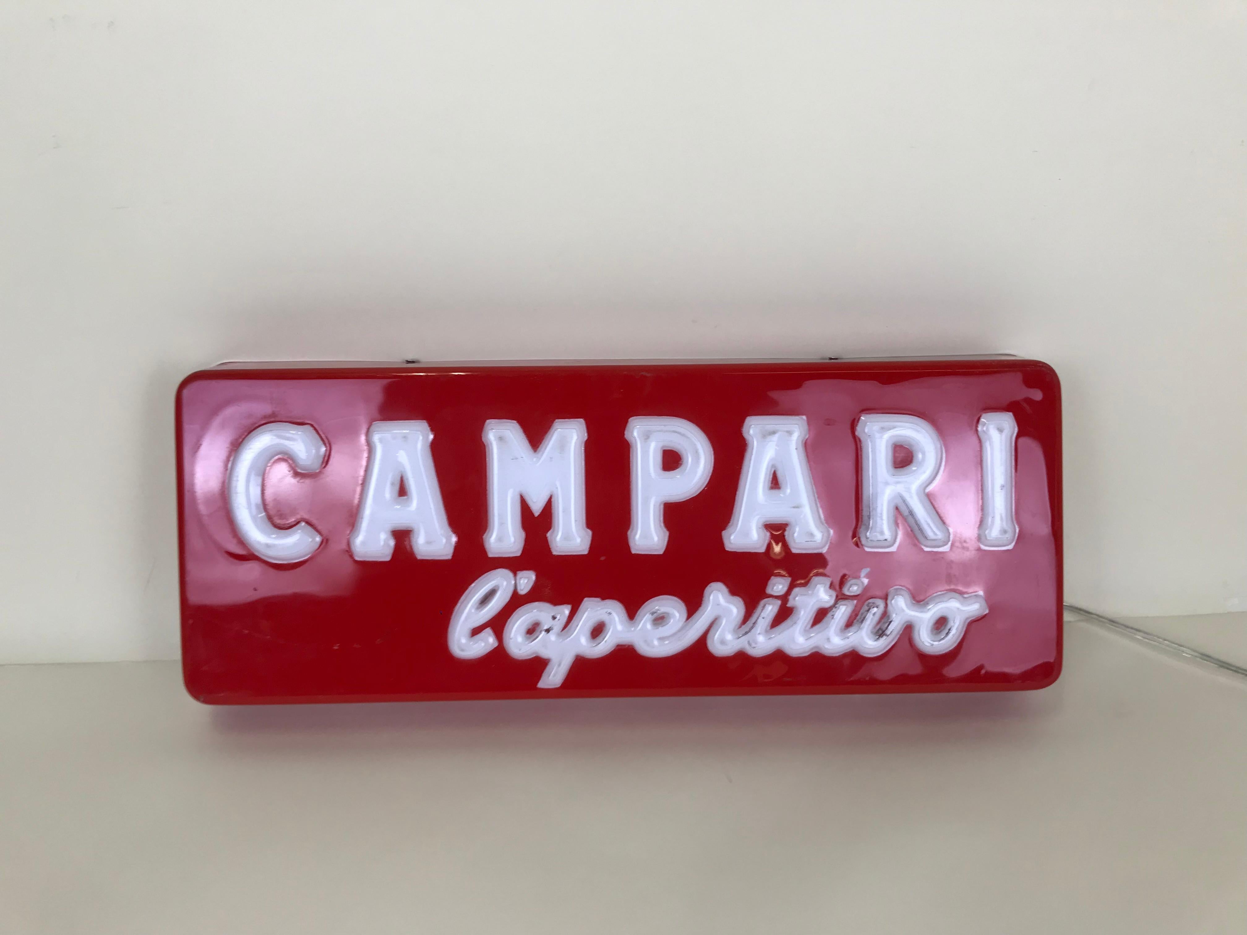 Campari l'aperitivo 'Campari the aperitif' illuminated sign with relief letters produced in Italy in early 1970s. This very rare sign it was displayed inside a selected numbers of Italian bar.

The back of the sign is not original: is now covered