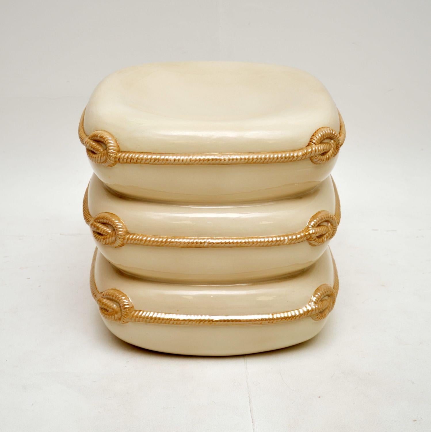 A stunning 1970’s vintage Italian ceramic stool in the form of three stacked cushions.

It is of lovely quality, it is a very striking and also functional piece of art. The top has a very slight dip, making it quite comfortable to perch on.

The