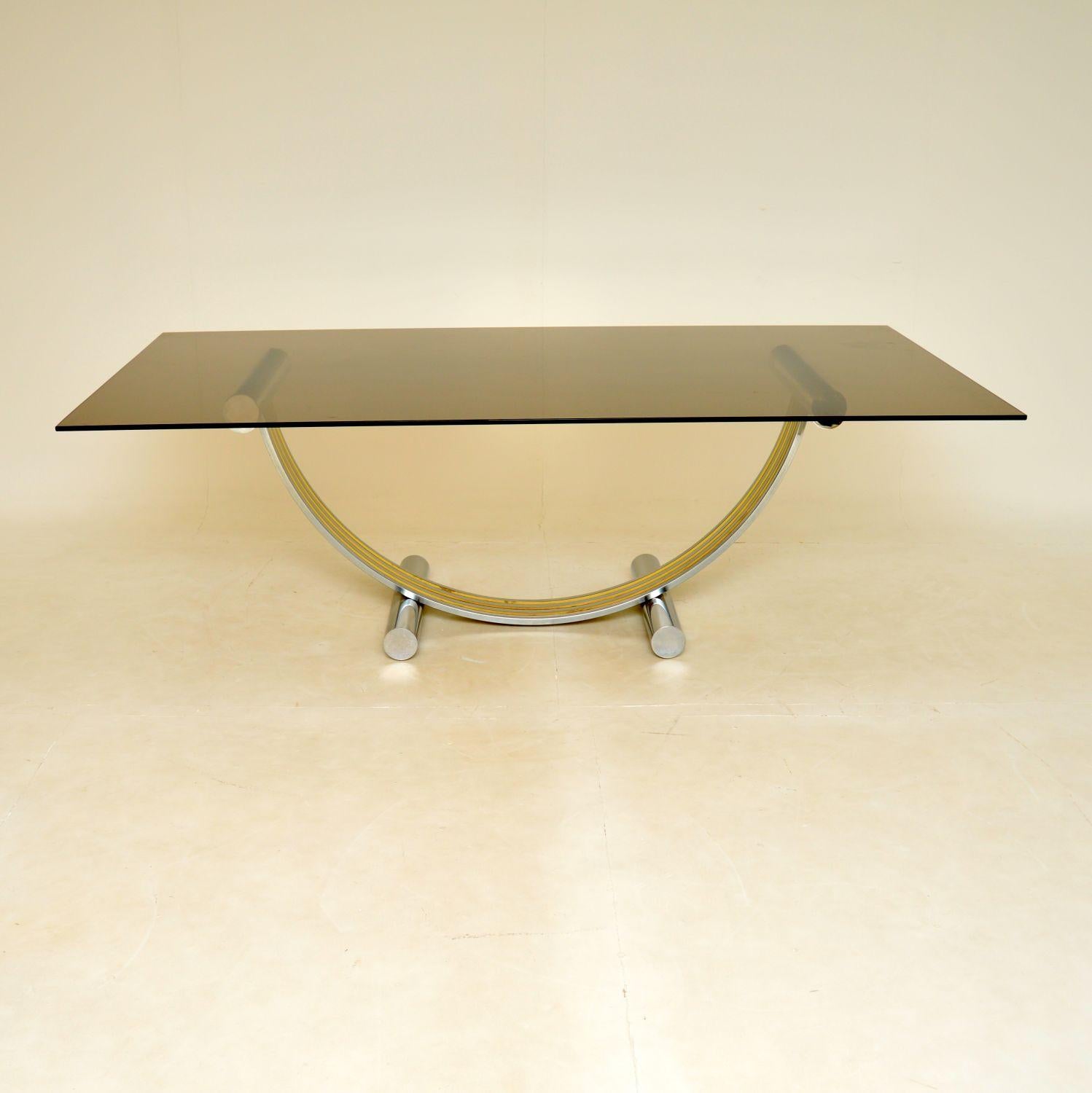 A large and absolutely stunning vintage Italian dining table by Renato Zevi. This was made in Italy, it dates from the 1970’s.

The quality is exceptional, the U shaped base is beautifully made from chrome and brass, and it supports a very thick