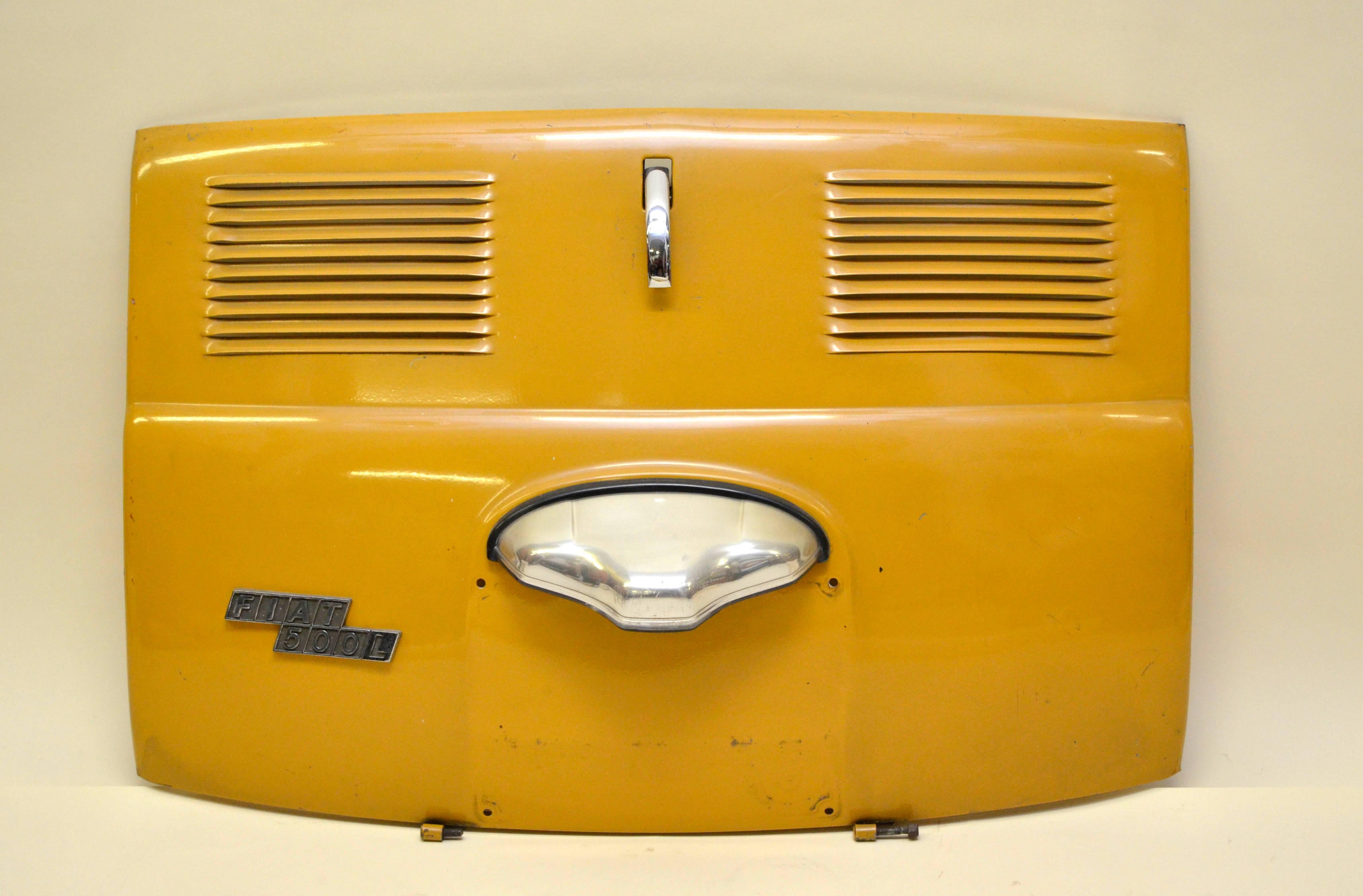 1970s vintage Fiat 500 L yellow trunk lid with steel parts. 

Collector's note.

The Fiat 500 was a rear-engined two-door, four seat, small city car manufactured and marketed by Fiat Automobiles from 1957-1975 over a single generation in