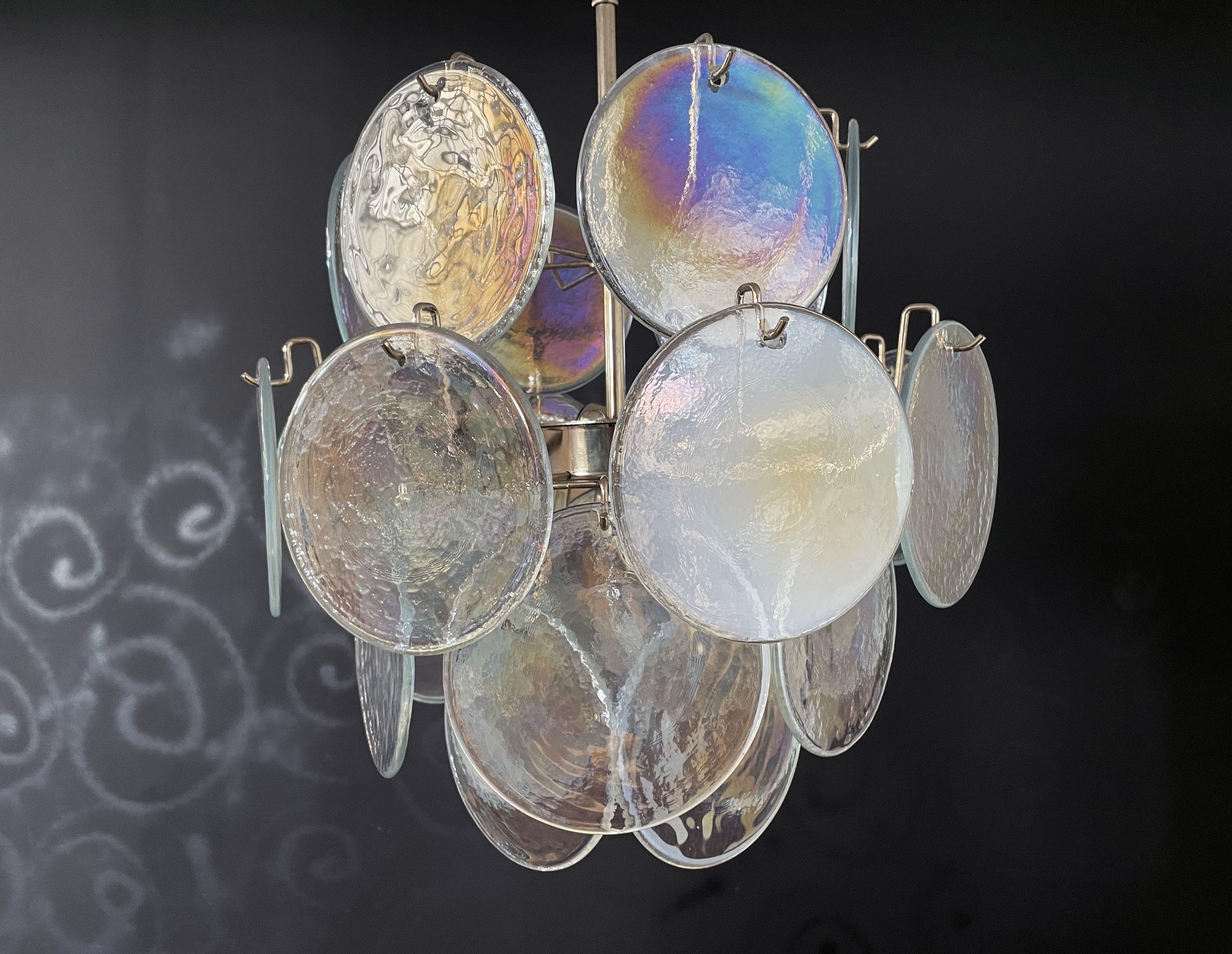 Vintage Italian Murano chandelier in Vistosi style. The chandelier has 24 fantastic iridescent discs in a nickel metal frame. The glasses have the particularity of reflecting a multiplicity of colors, which makes the chandelier a true work of