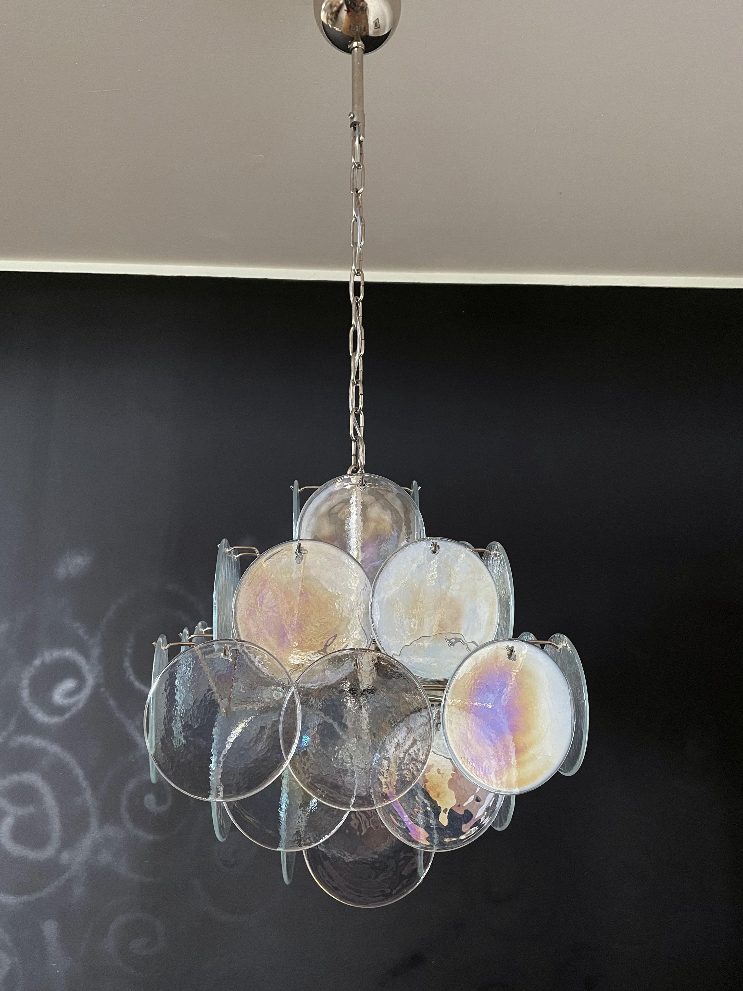 Vintage Italian Murano chandelier in Vistosi style. The chandelier has 36 fantastic iridescent discs in a nickel metal frame. The glasses have the particularity of reflecting a multiplicity of colors, which makes the chandelier a true work of