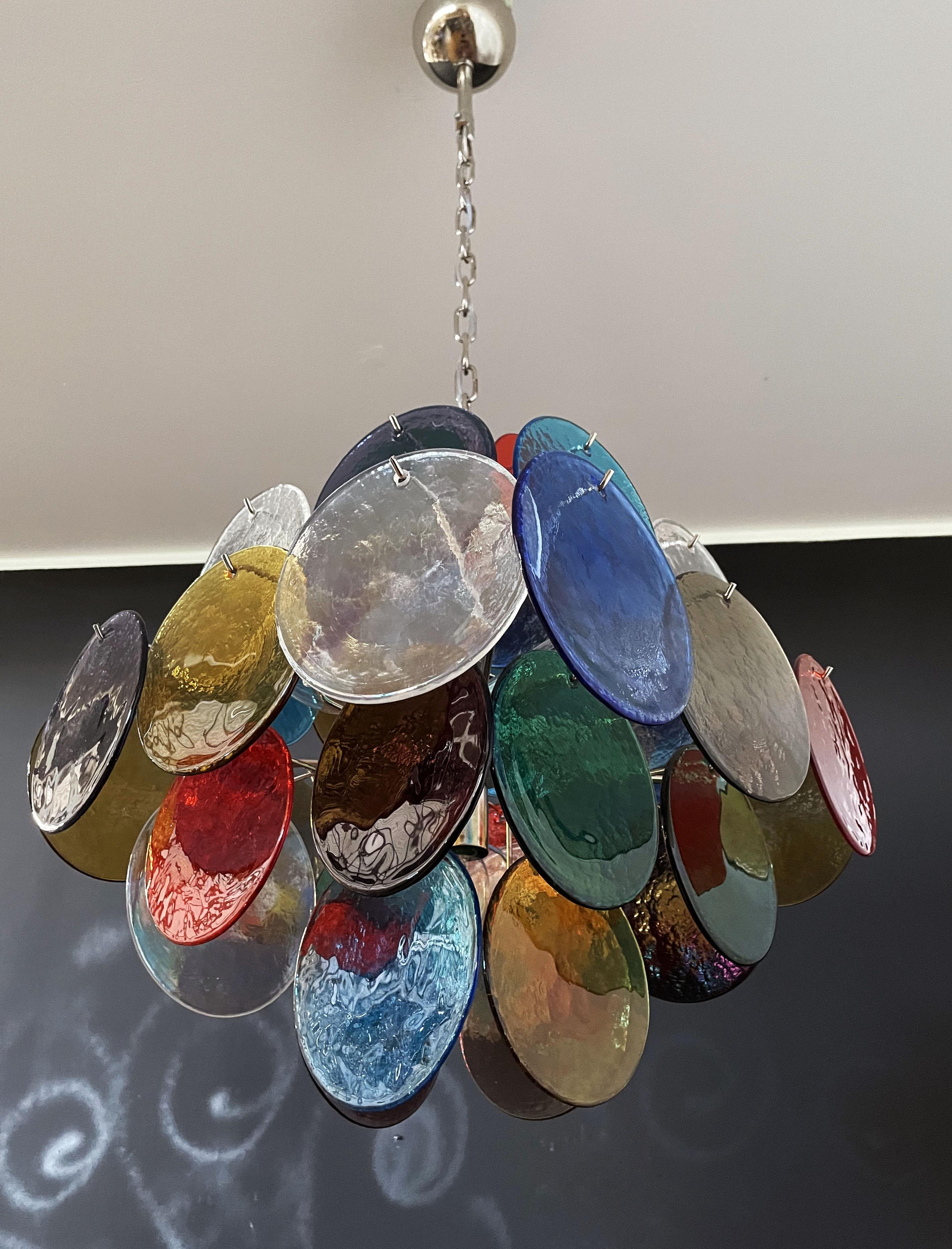 Vintage Italian Murano chandelier in Vistosi style. The chandelier has 36 fantastic multicolored discs in a nickel metal frame.
Period: late 20th century
Dimensions: 44.50 inches (150 cm) height with chain; 19.40 inches (50 cm) height without