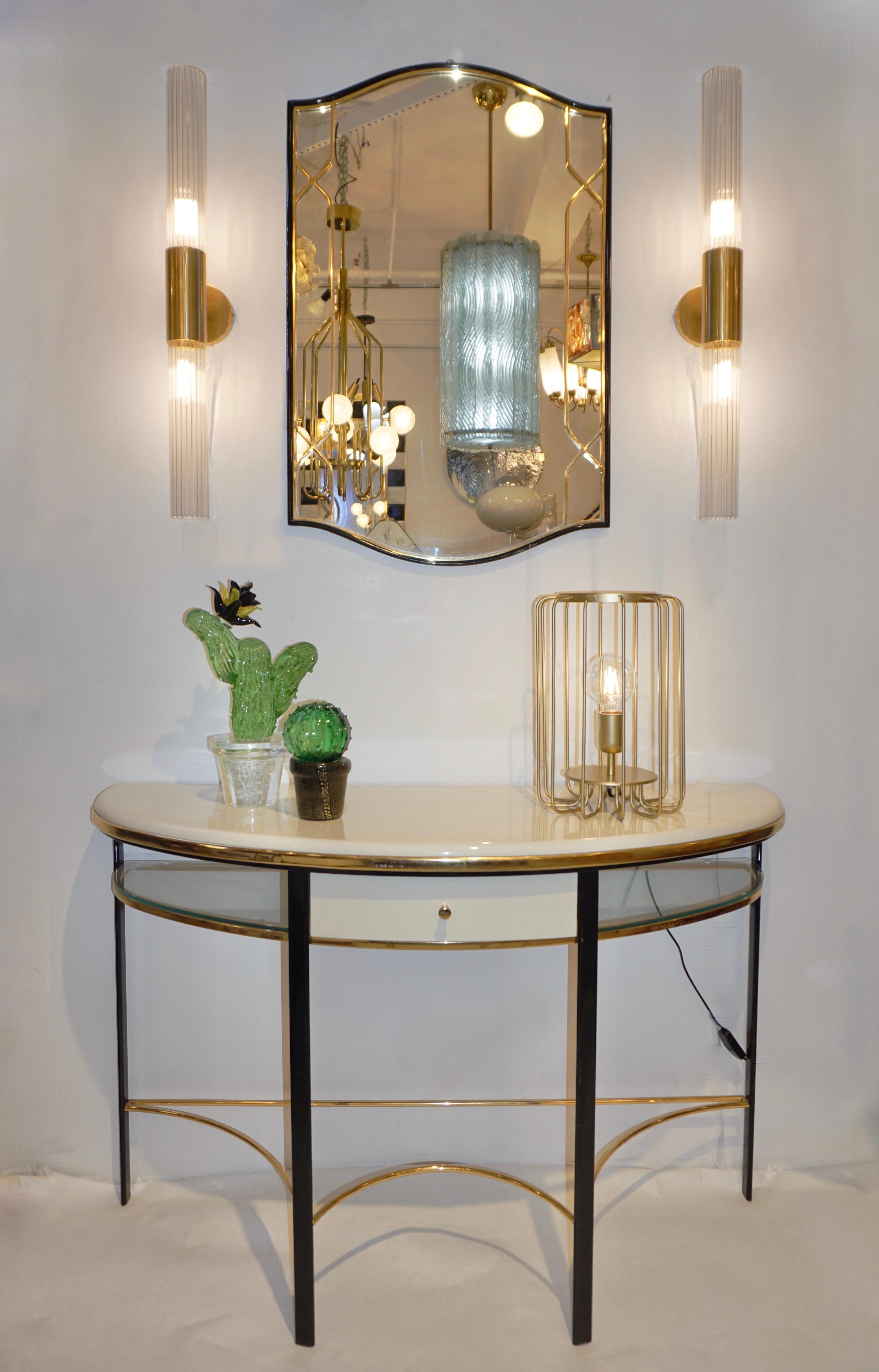 1970s vintage Italian one-of-a-kind Art Deco Design demilune console in black, ivory cream, and gold, entirely handcrafted. The functional architectural half-round metal frame has an ivory cream lacquered wood top, elegantly fitted with arched glass