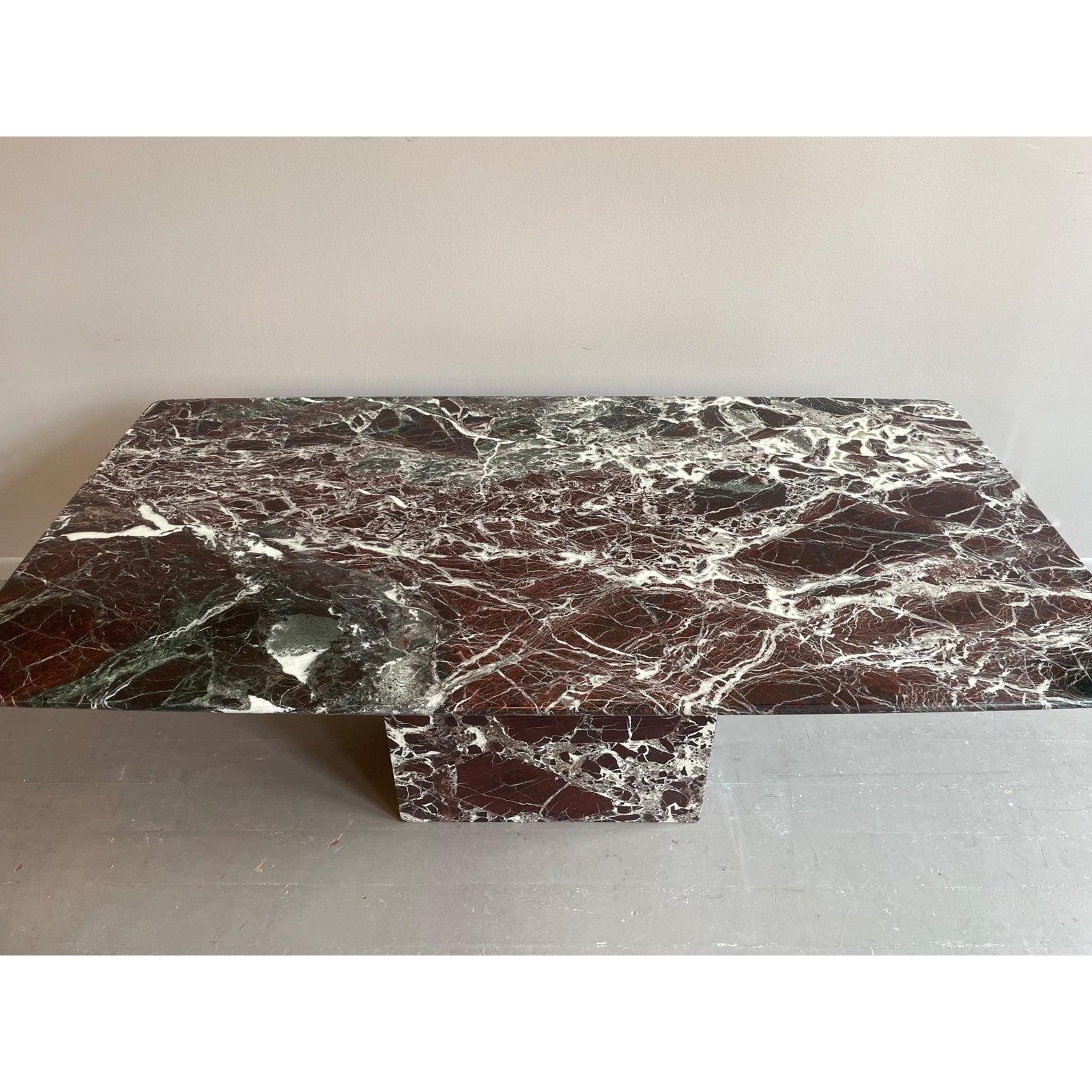 We are very pleased to offer a cushion shaped (not oval not rectangle) dining table, made in Italy, circa the 1970s. Crafted from Rosso Levanto marble, a luxurious marble known for its deep burgundy hue, interspersed with veins of white and gray,