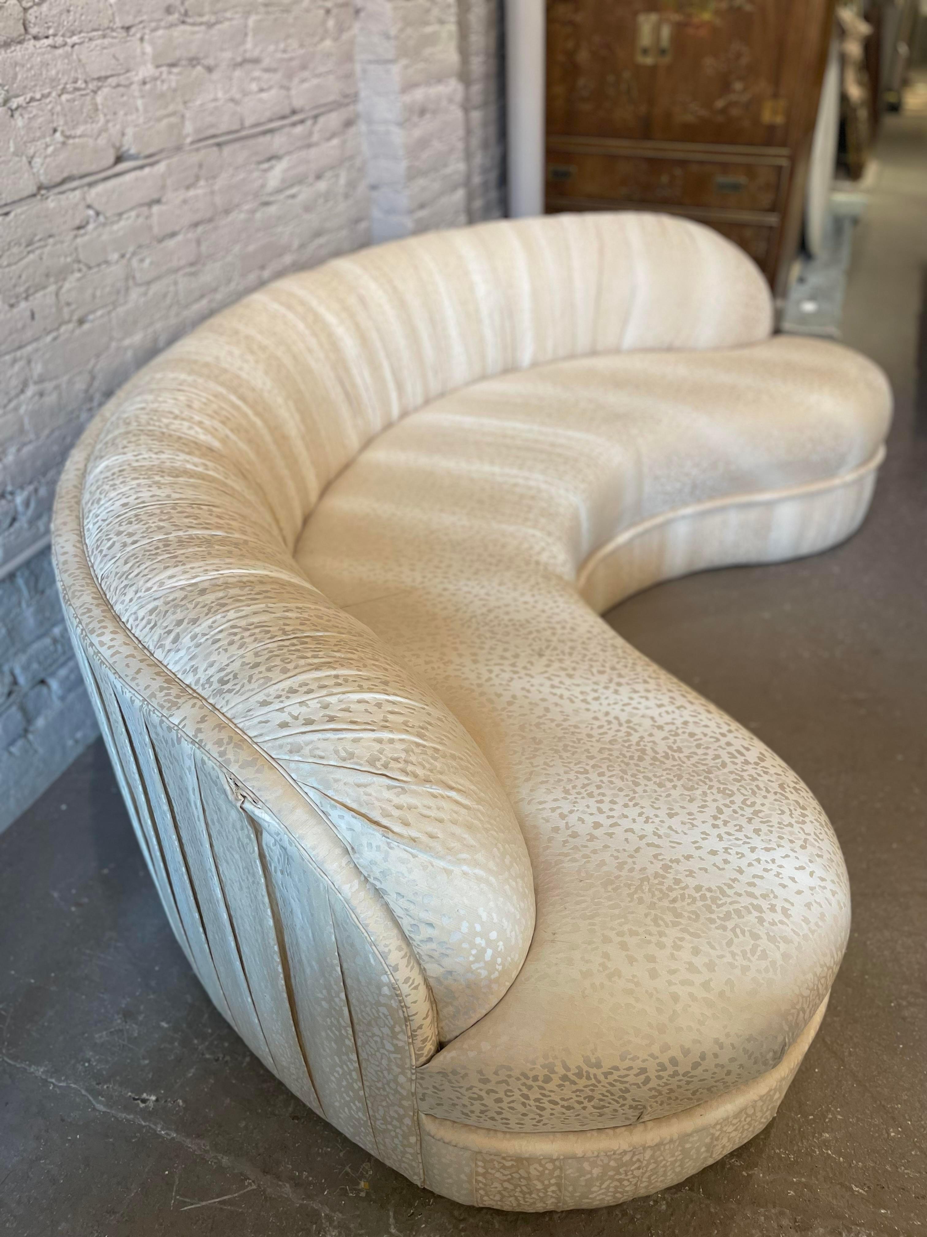 Beautiful and incredibly well build curved sofa. Perfect for a living room or dining banquet. This is very heavy and the cushions are in excellent condition. Use as is or redo in your favorite fabric. Structurally very very sound.
